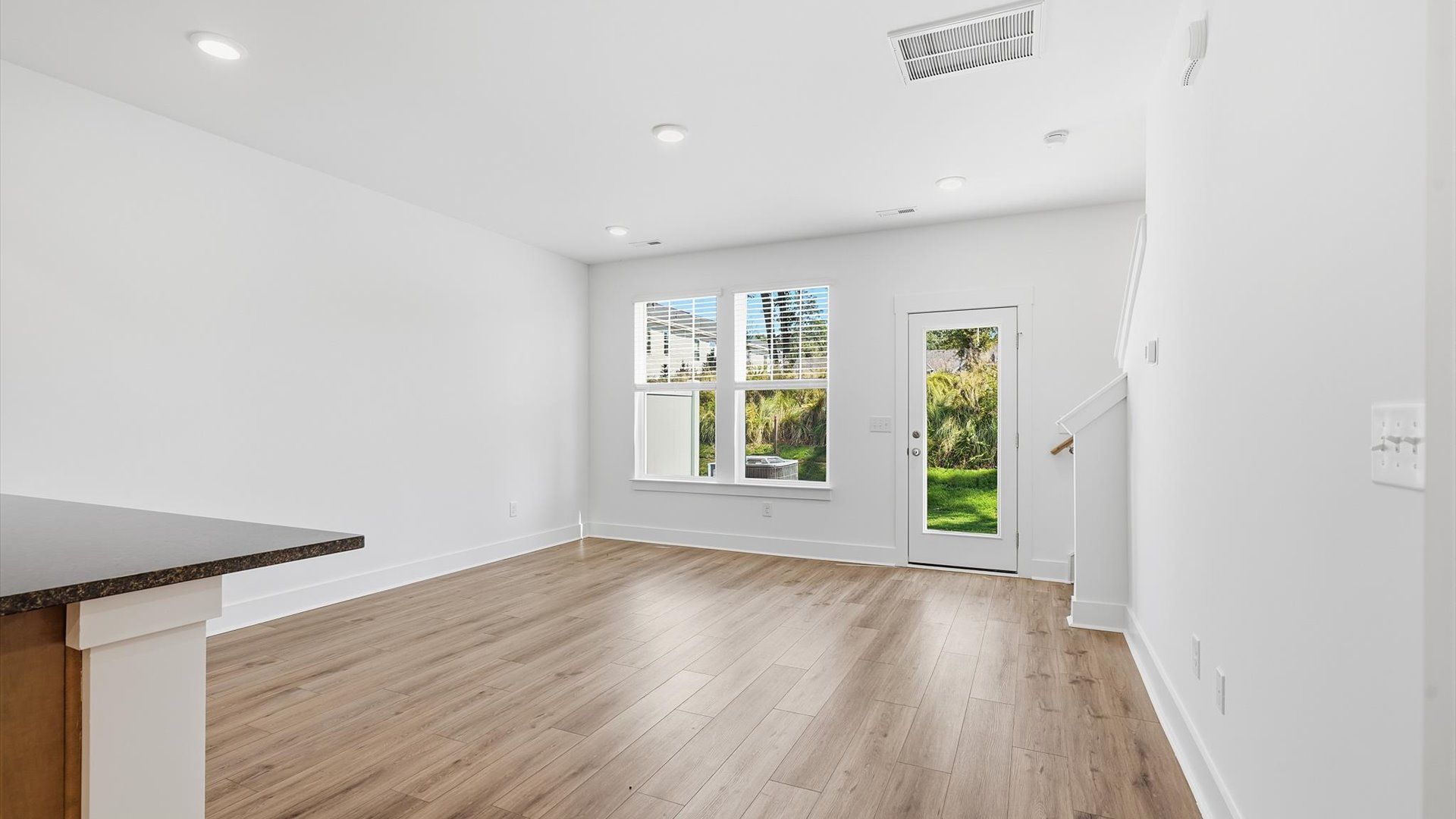 Memorable moments begin in this elegant, open family room with hardwood flooring and refined finishes