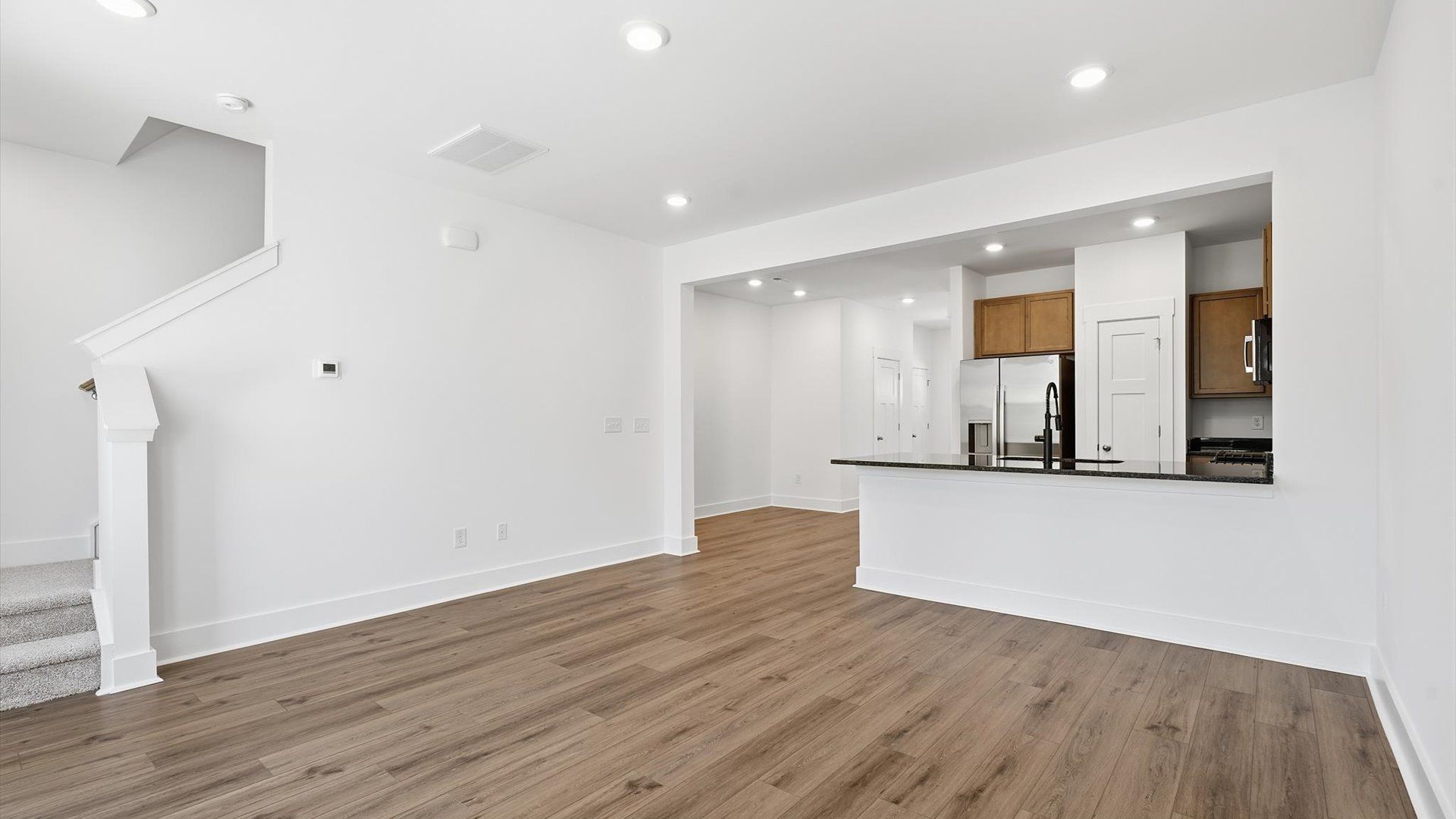 First-rate family room with thoughtful layout and superior connection to kitchen and dining spaces by DRB Homes
