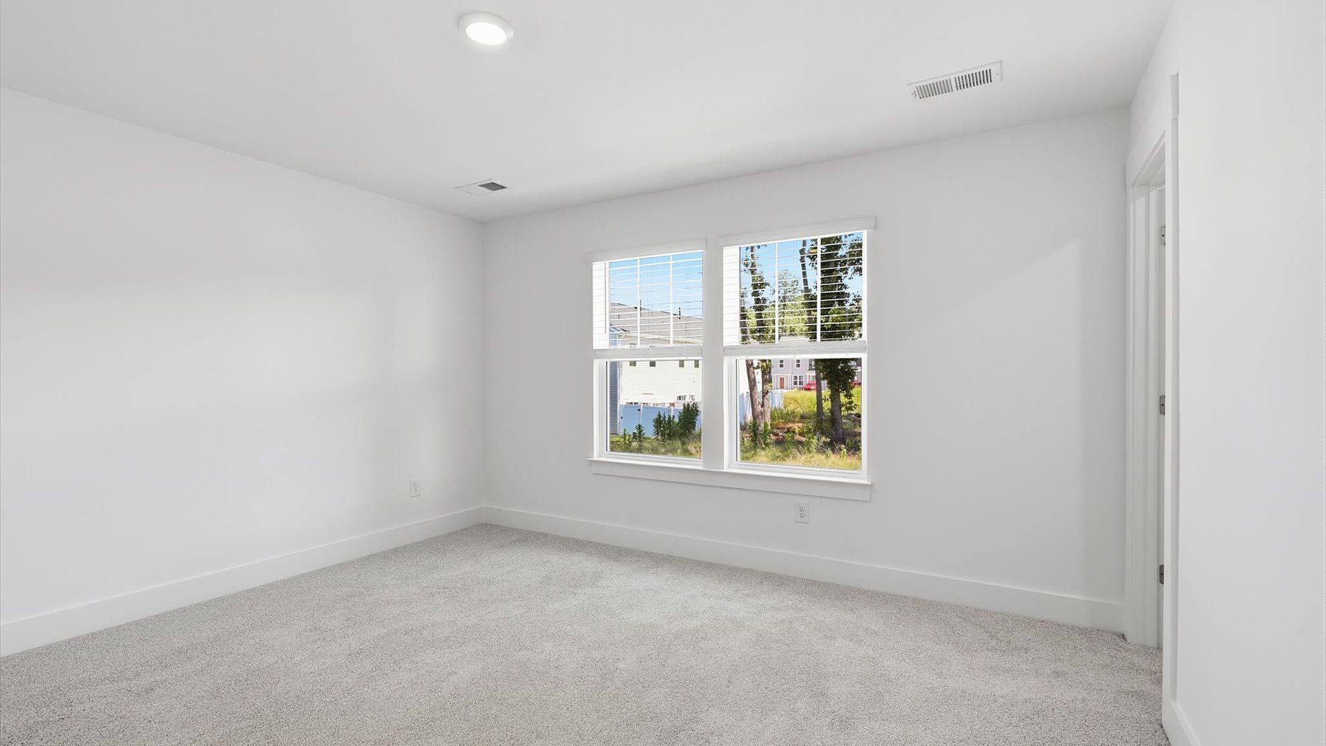 Vibrant natural light fills this exceptional primary suite with eye-catching details at Clarke Townes