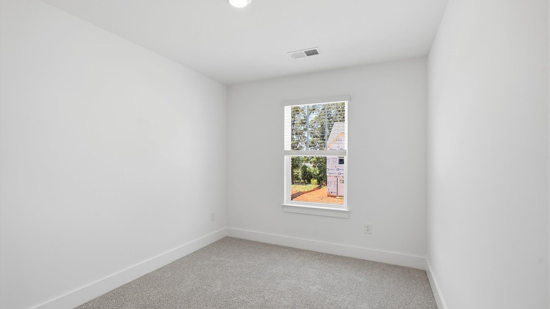 Refined bedroom design with a large window for daylight-filled mornings and peaceful views in Anderson, SC