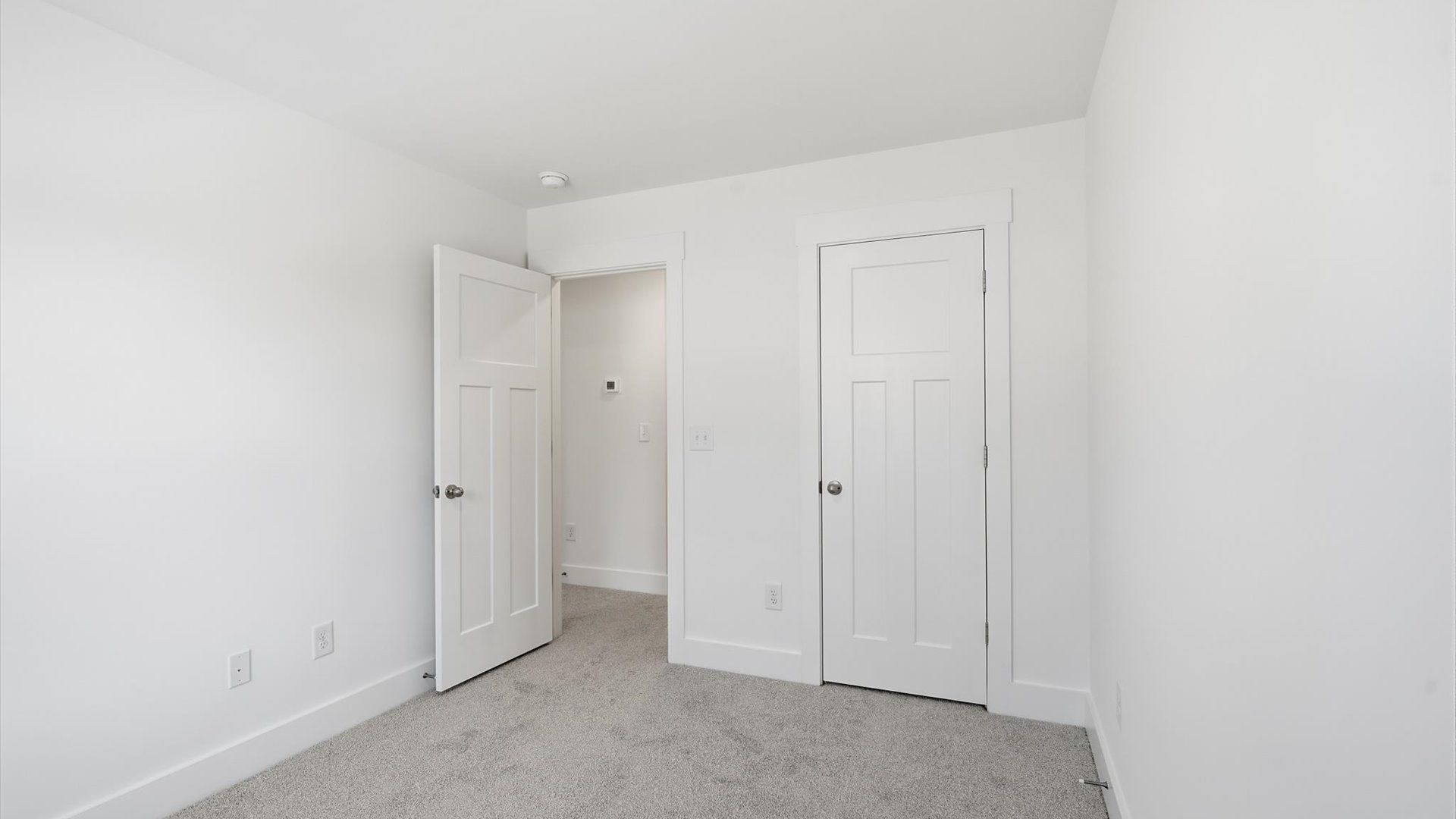 First-class secondary bedroom with comfortable carpeted flooring and generous closet space at Clarke Townes