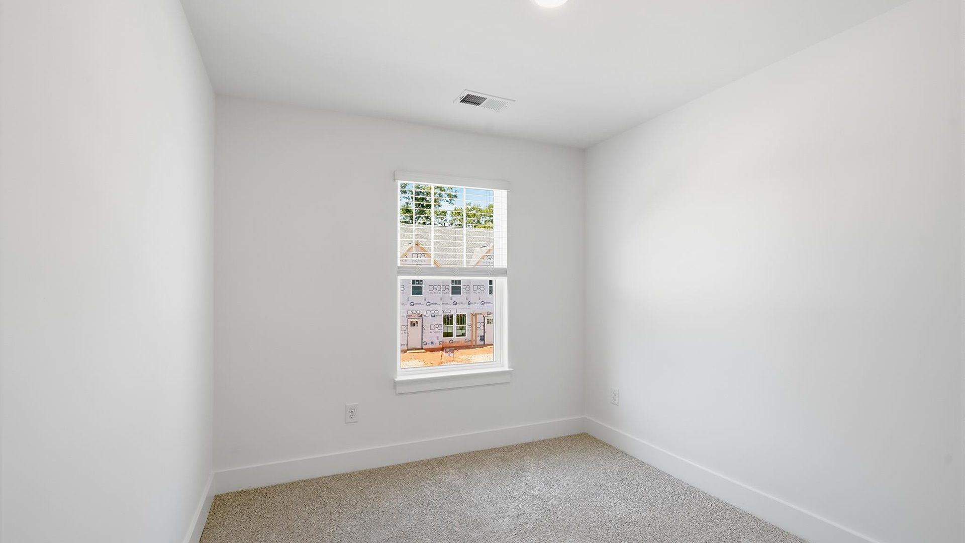 Inviting bedroom with tasteful finishes and a large window that create a fresh, open ambiance near Downtown Anderson