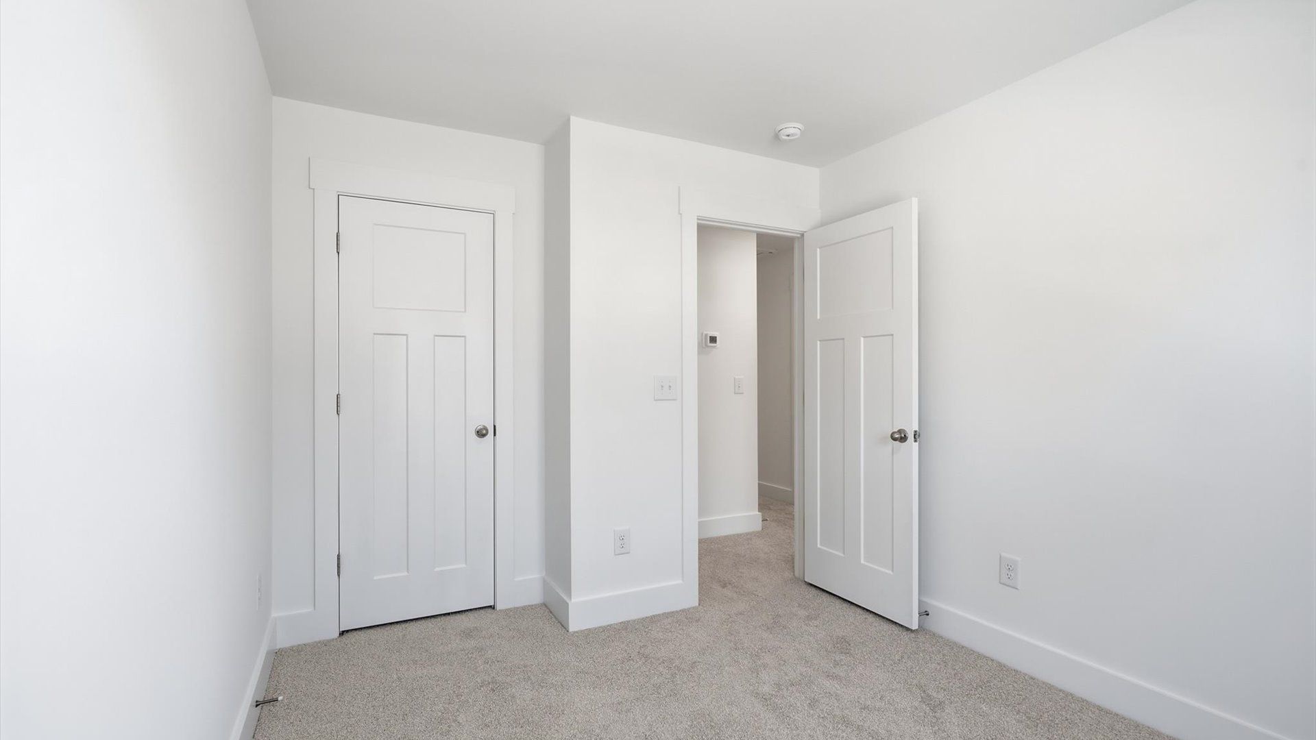 Superior comfort in a secondary bedroom with plush carpet and an oversized walk-in closet at Clarke Townes