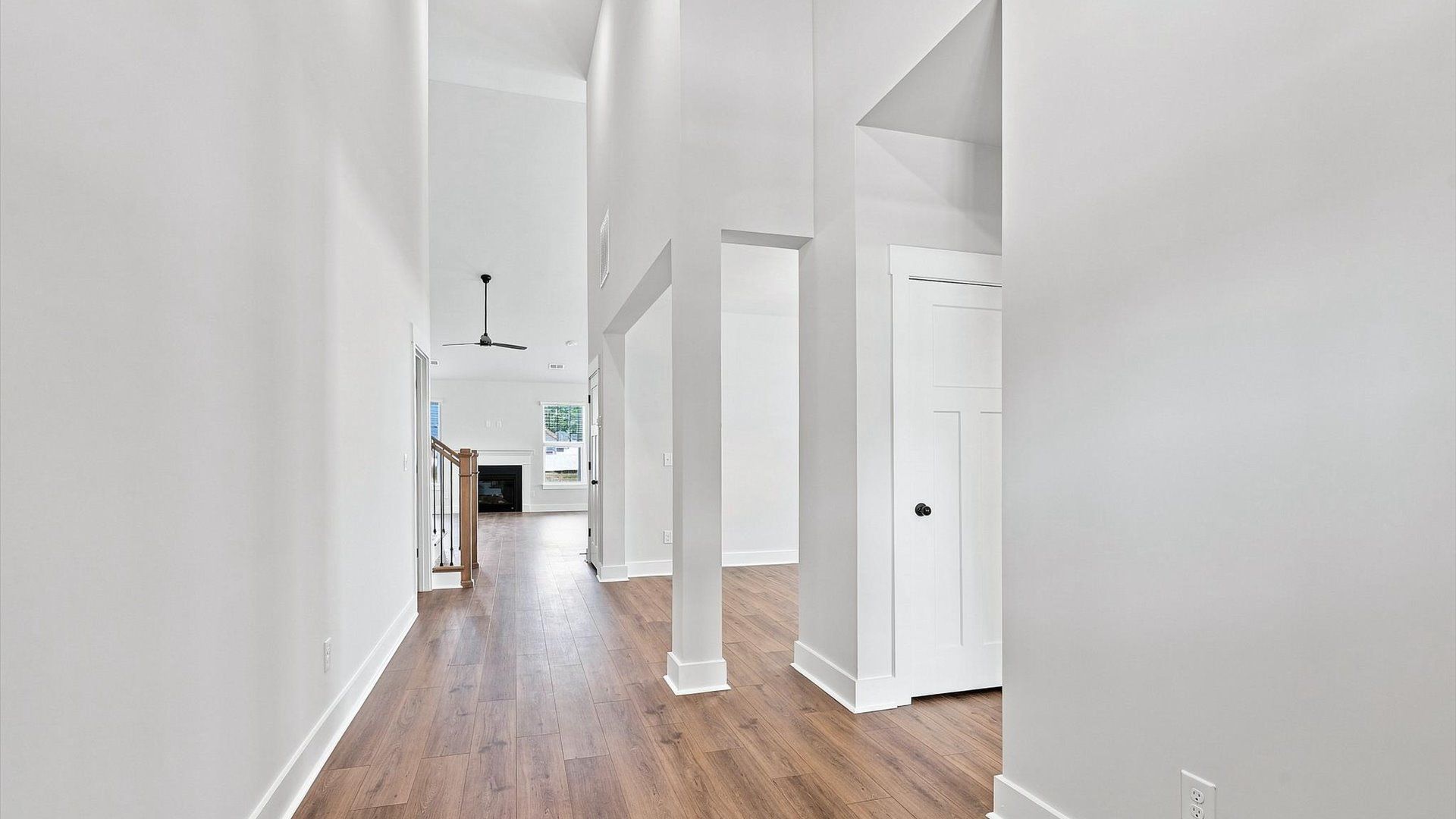 Memorable arrival experience with hardwood floors and elegant trim in the foyer