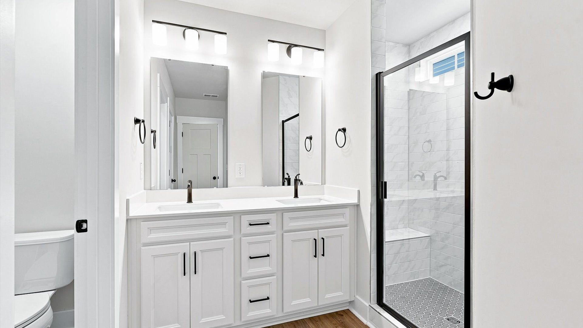 Exceptional en-suite with dual vanity and glass-enclosed tiled walk-in shower for superior everyday comfort