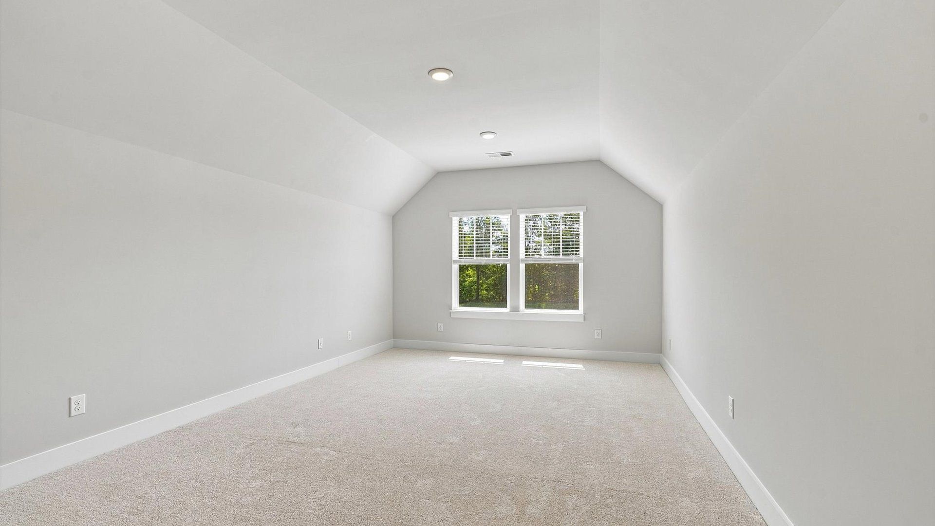 Bright bonus room with flexible space for a media room, home office, or playroom