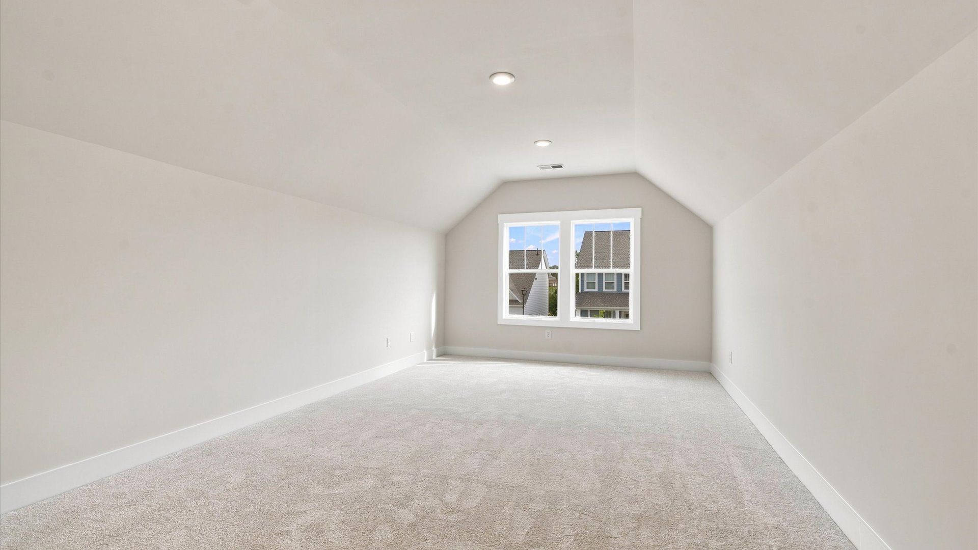 Inviting bonus room with cozy carpet, perfect for casual gatherings or quiet relaxation at Wells Crossing
