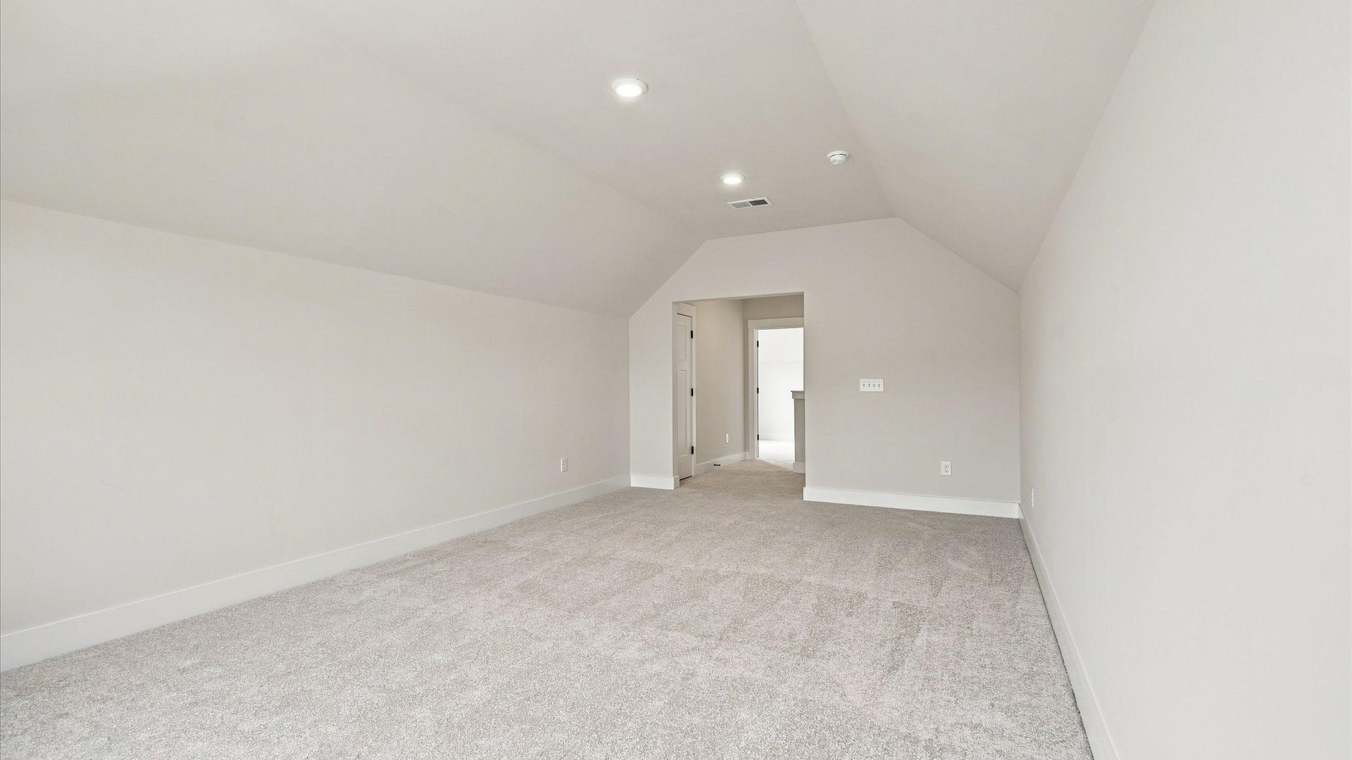 Vibrant carpeted bonus room offering flexibility as a study nook, game room, or second family space by DRB Homes