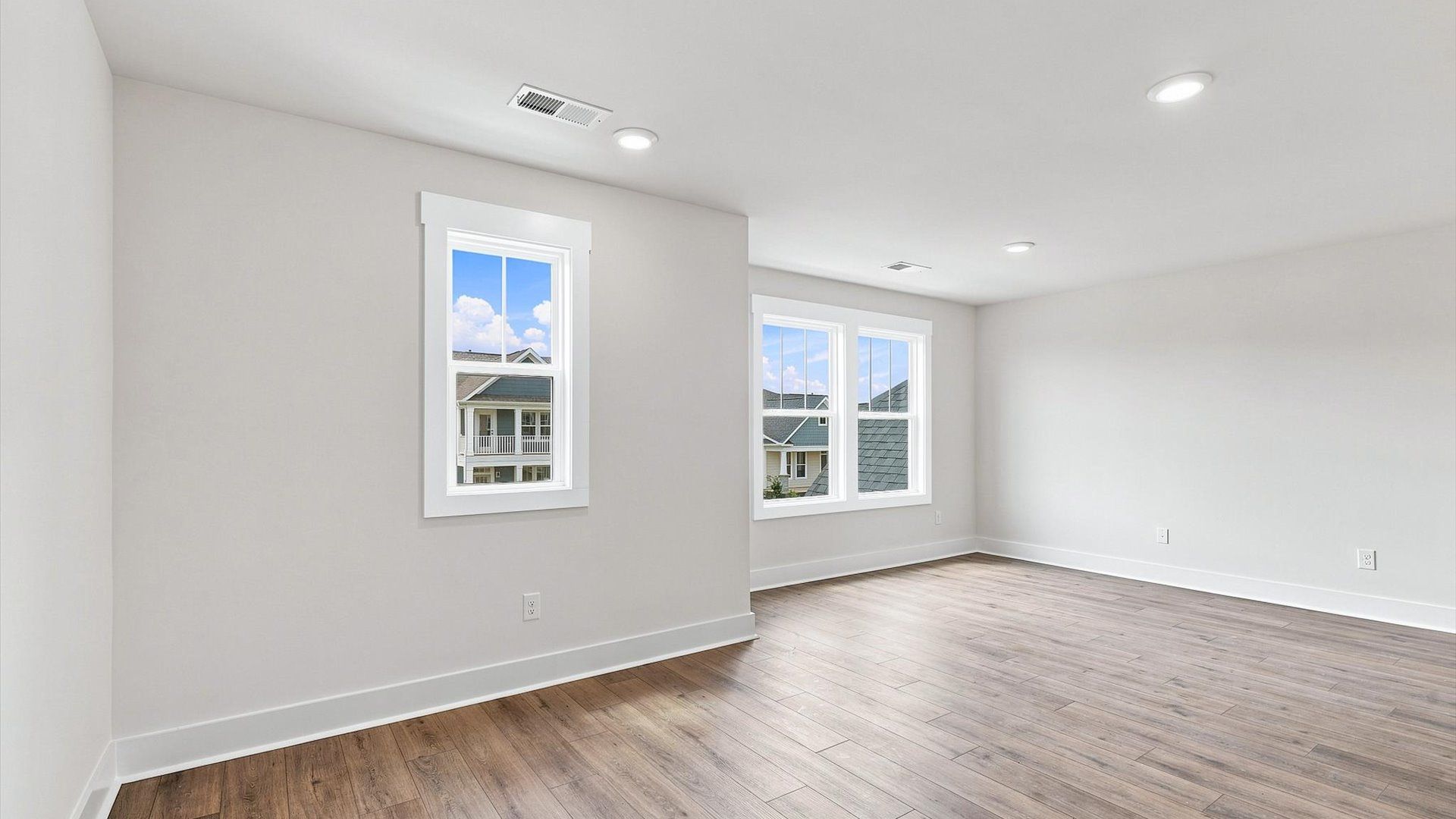 First-class loft showcasing hardwood floors and an adaptable space for every stage of life