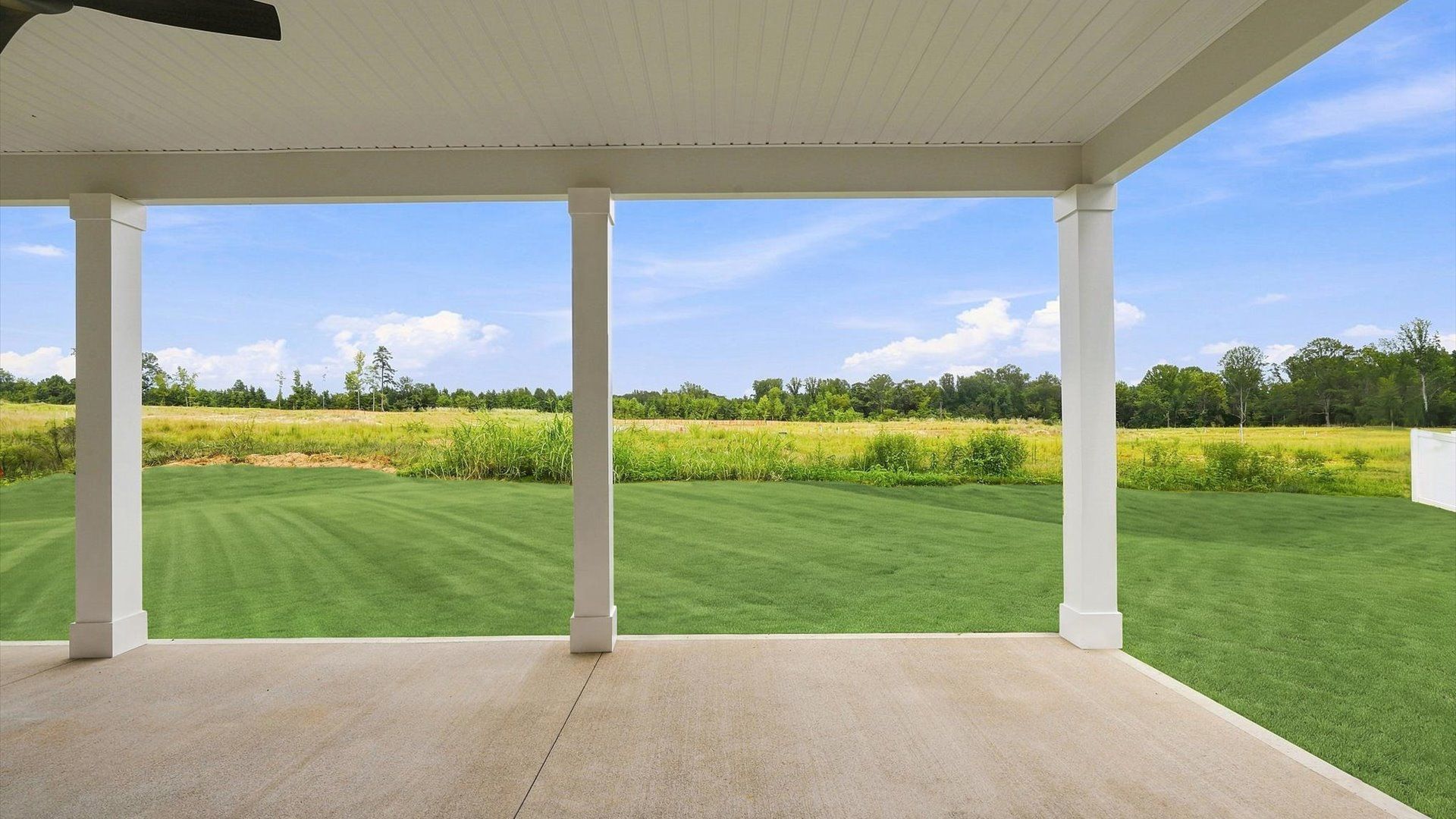 Warm and inviting outdoor living space with a covered rear porch and tasteful finishes