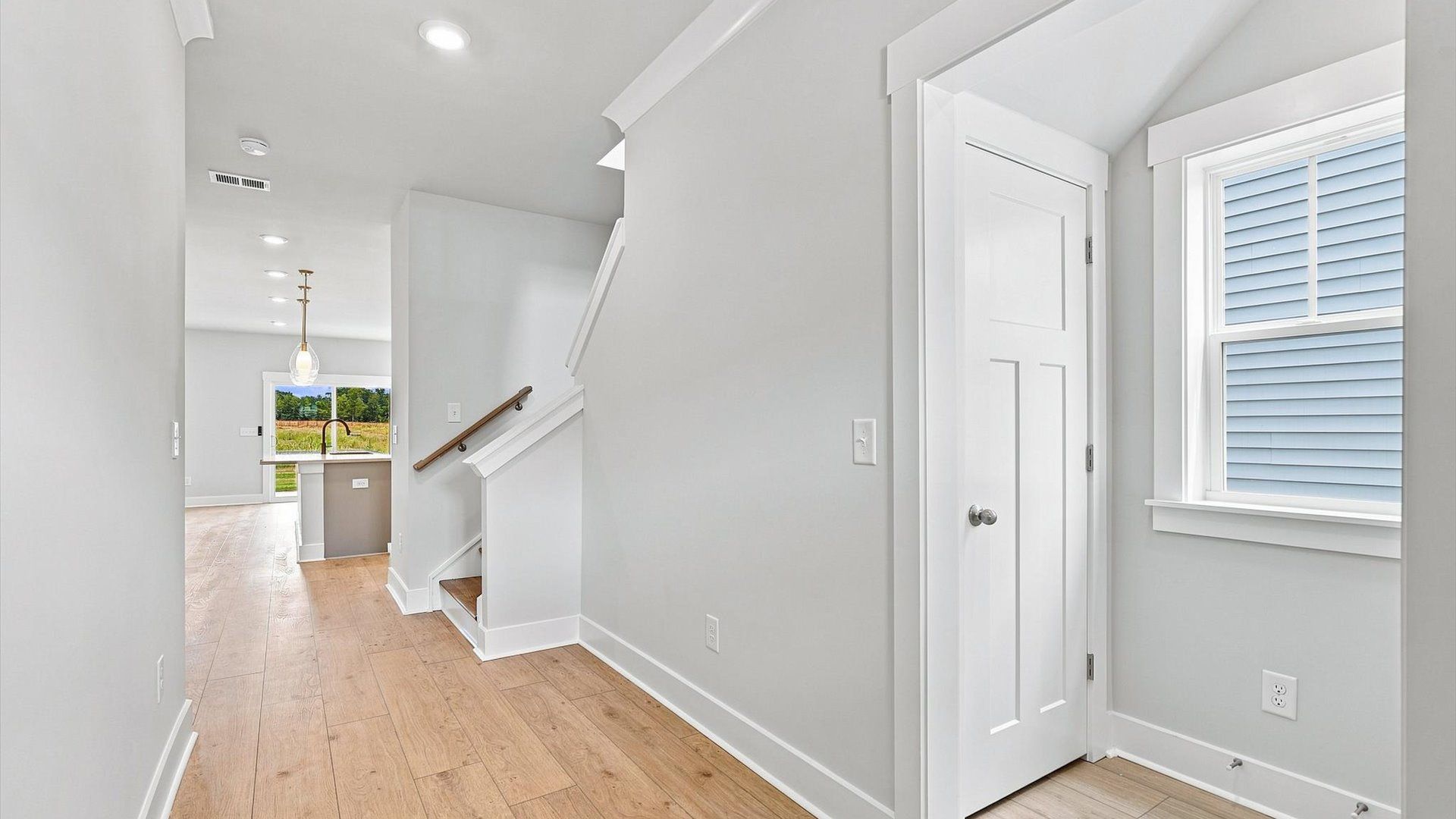 Refined foyer with hardwood floors and thoughtful design for a first-rate welcome