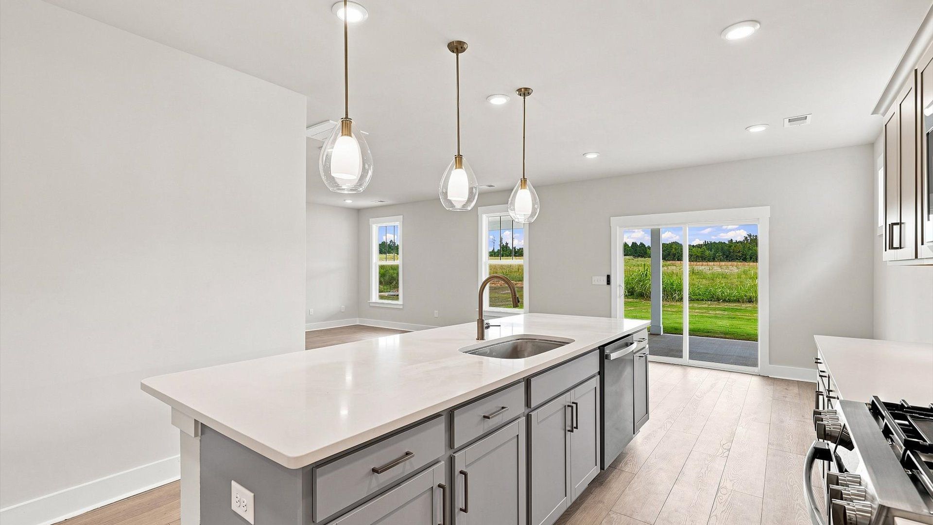 Memorable meals begin in this vibrant kitchen with pendant lighting and a thoughtfully designed island