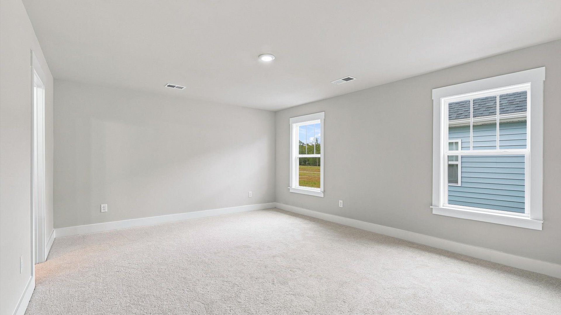 Vibrant natural light fills this exceptional primary suite with eye-catching details