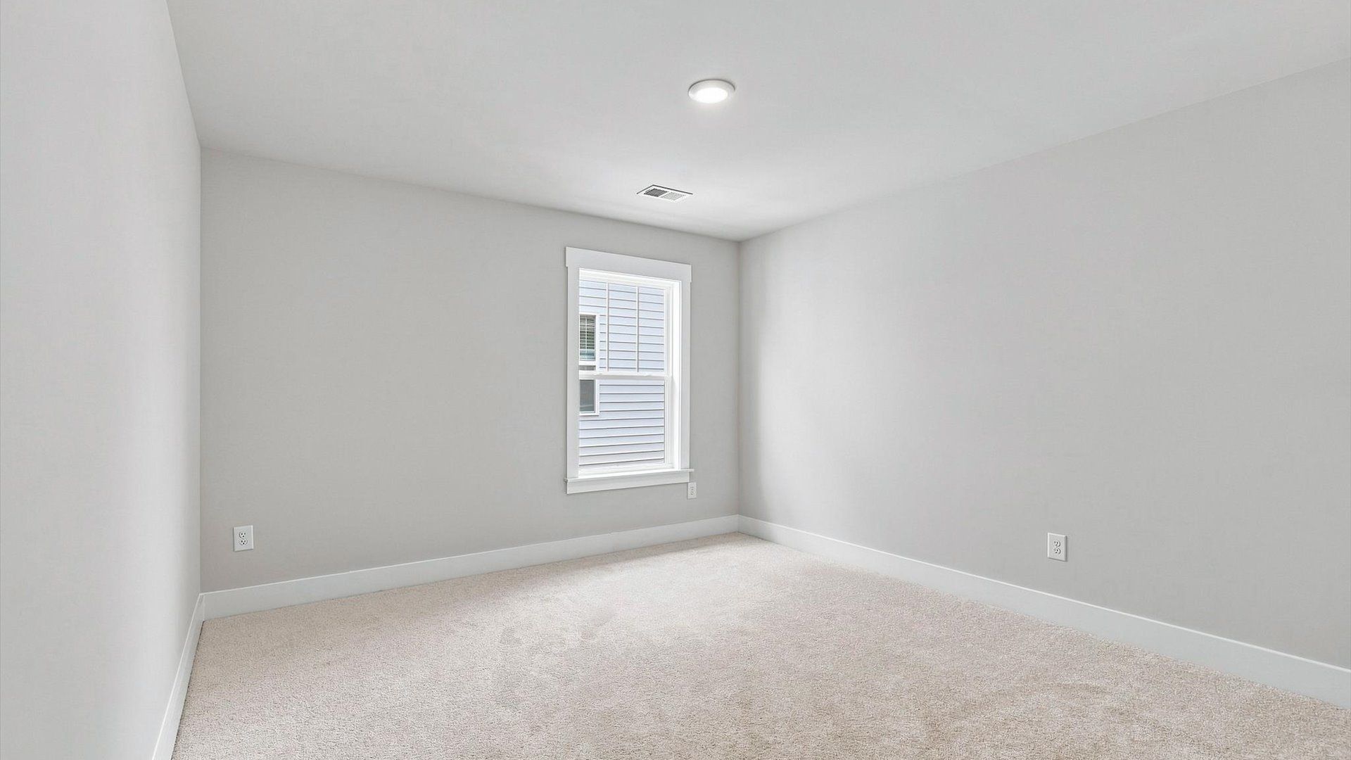 Refined bedroom design with large windows for daylight-filled mornings and peaceful views