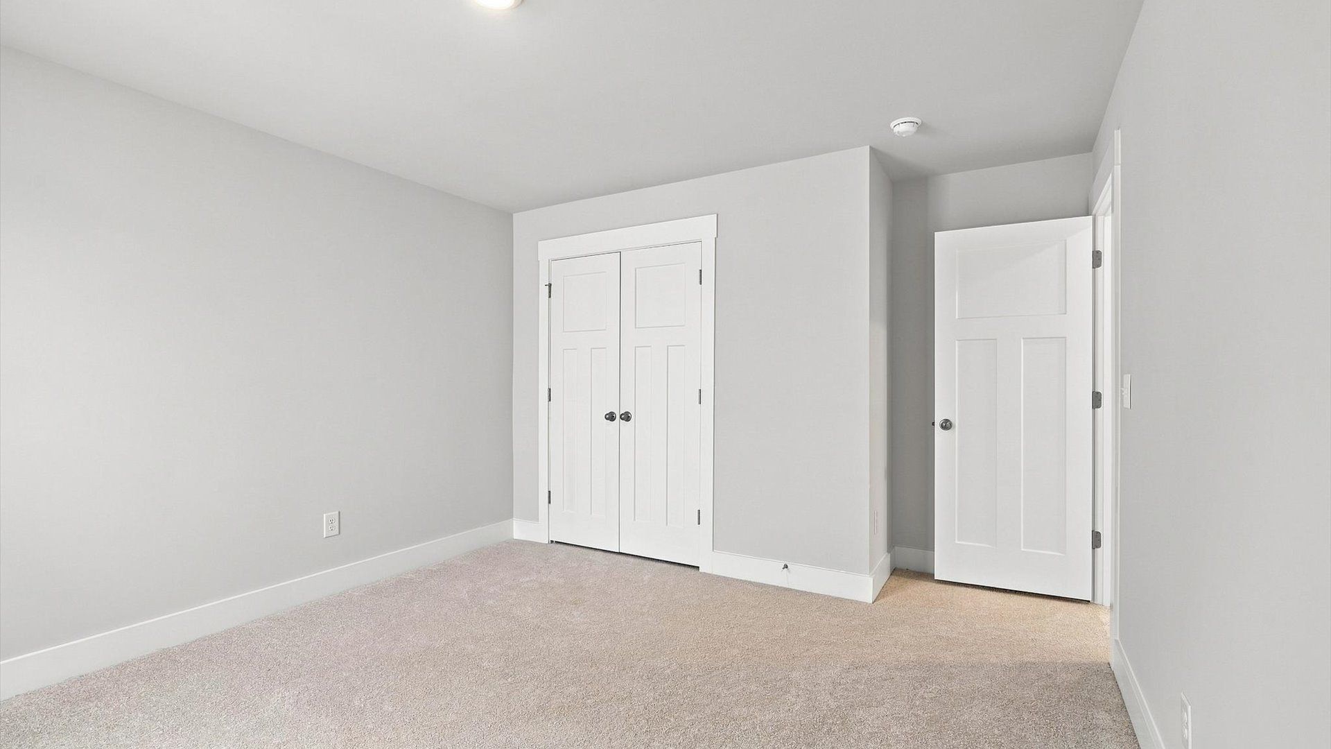 First-rate bedroom with plush carpeting and large windows that provide an open, airy feel