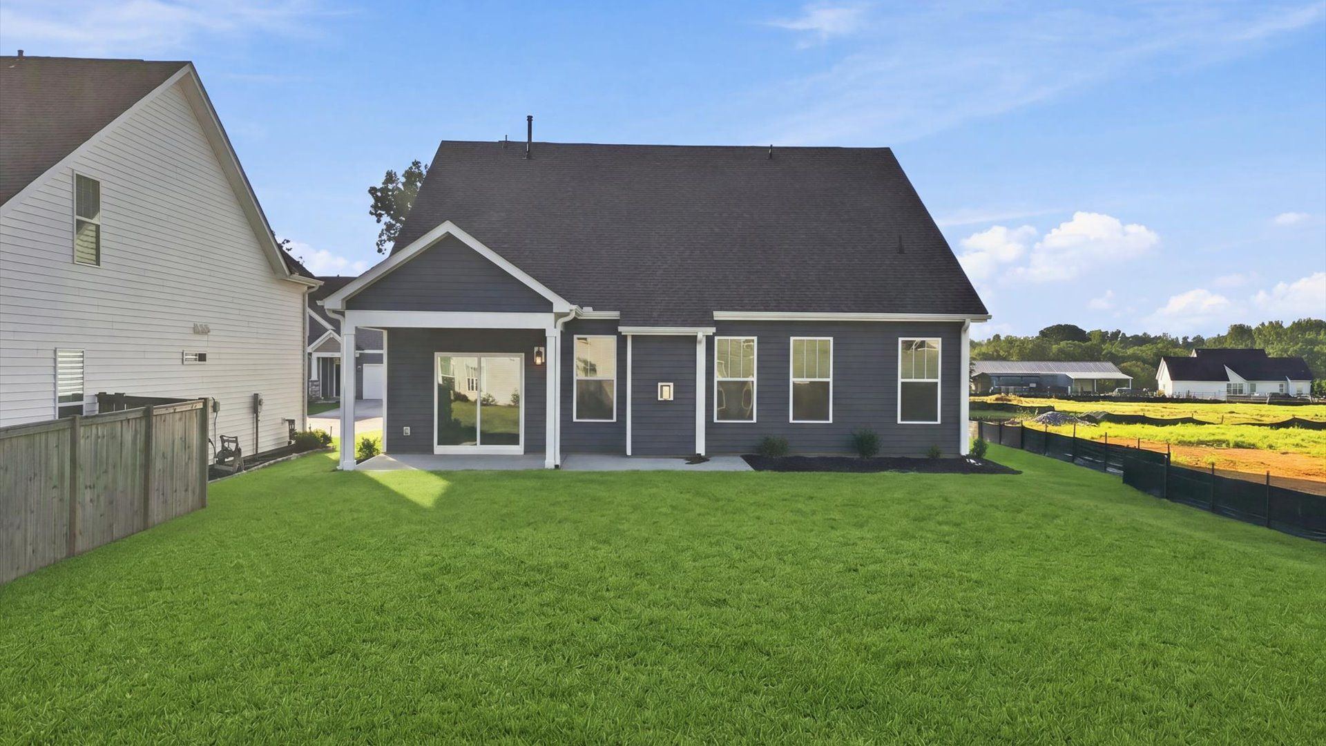 Warm and inviting outdoor living space with a covered rear porch and tasteful finishes at the Walnut Ridge community