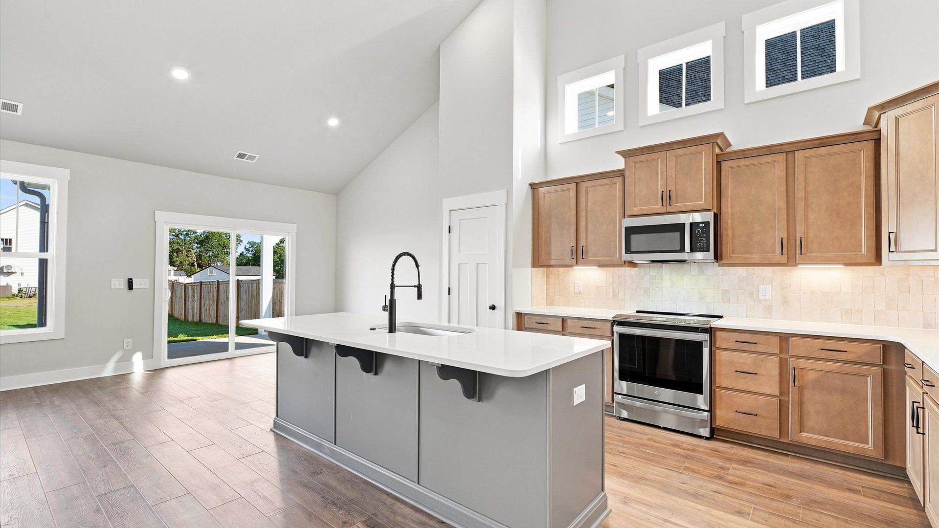 Accomplished design in a kitchen that blends function and form with a right-sized island by DRB Homes