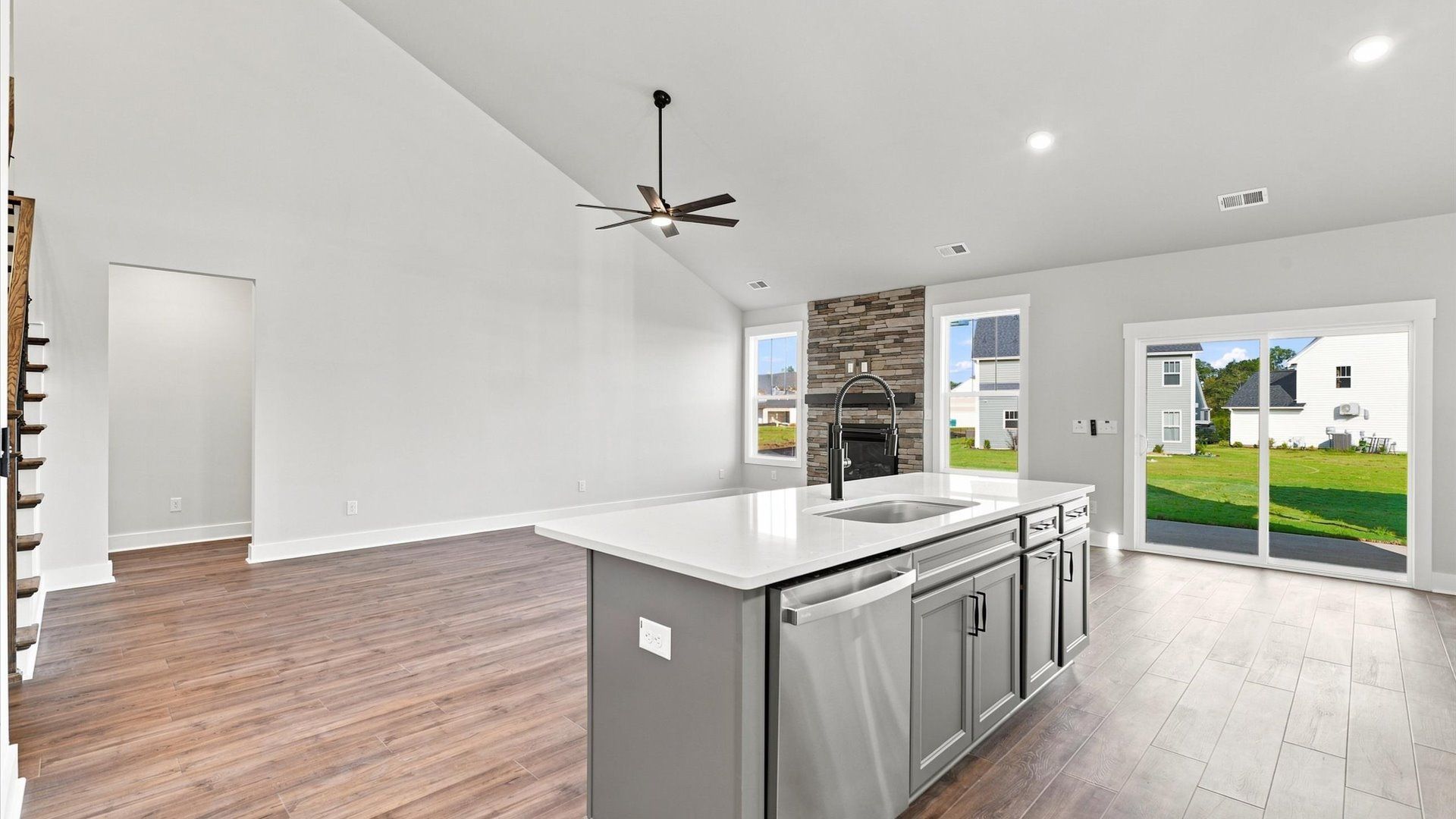 Superior kitchen with quartz countertops, stainless appliances, and a generously sized island located at Walnut Ridge