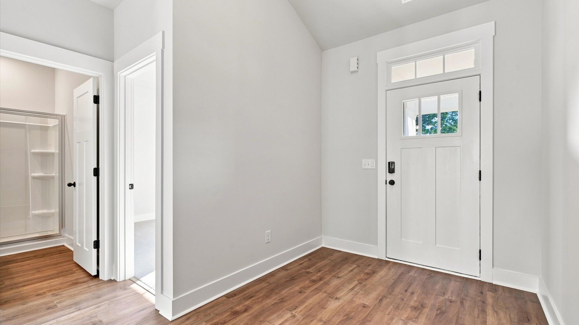 Accomplished hardwood flooring foyer sets the tone for tasteful design throughout the home at the Walnut Ridge community