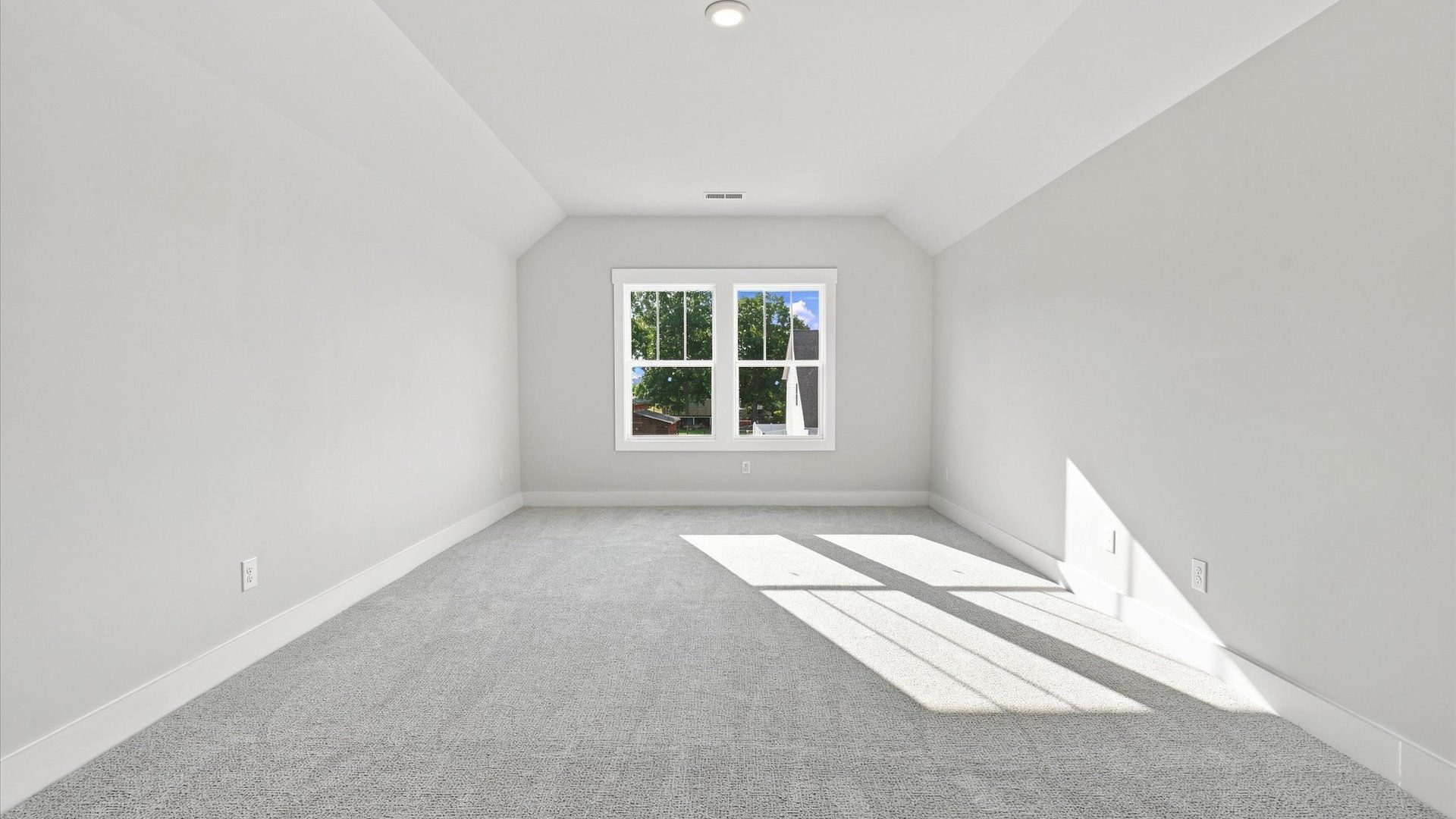 Top-notch design defines this bonus room with carpeted floors and an open, airy layout in Inman, SC