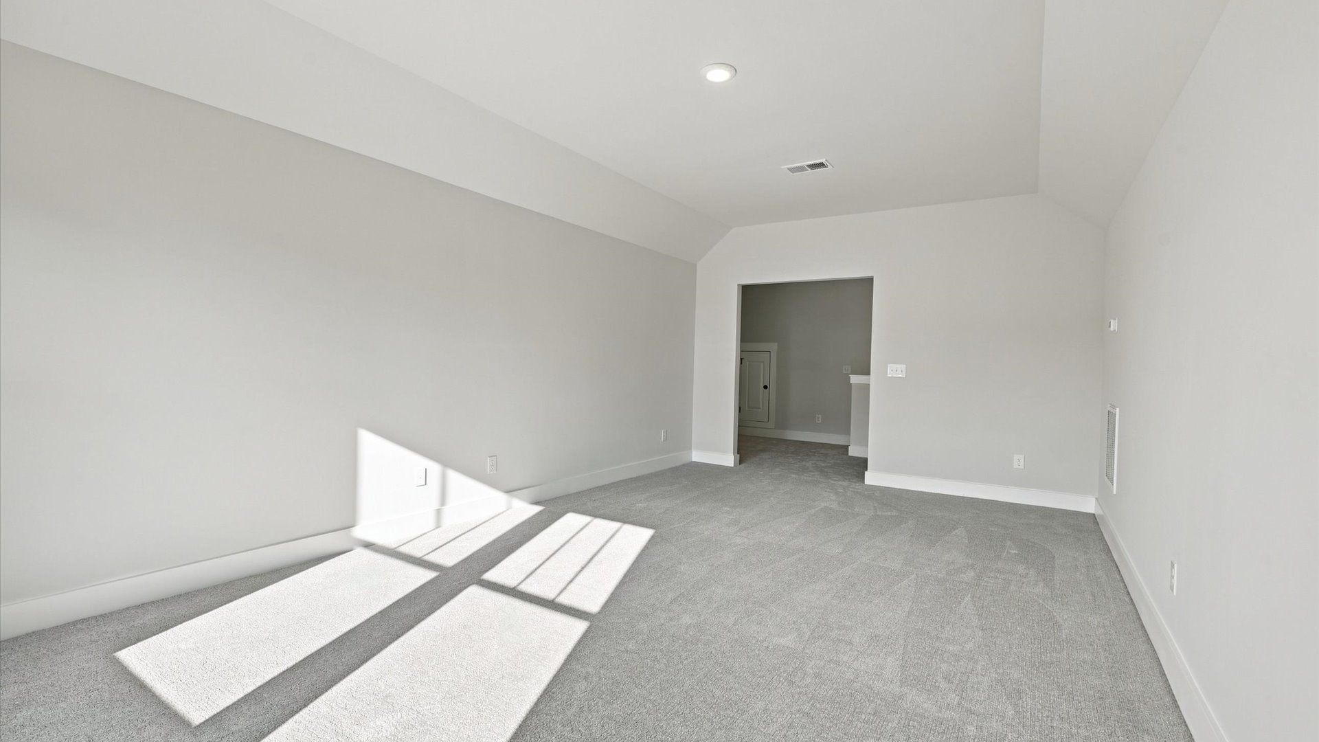 Vibrant carpeted bonus room offering flexibility as a study nook, game room, or second family space at Walnut Ridge