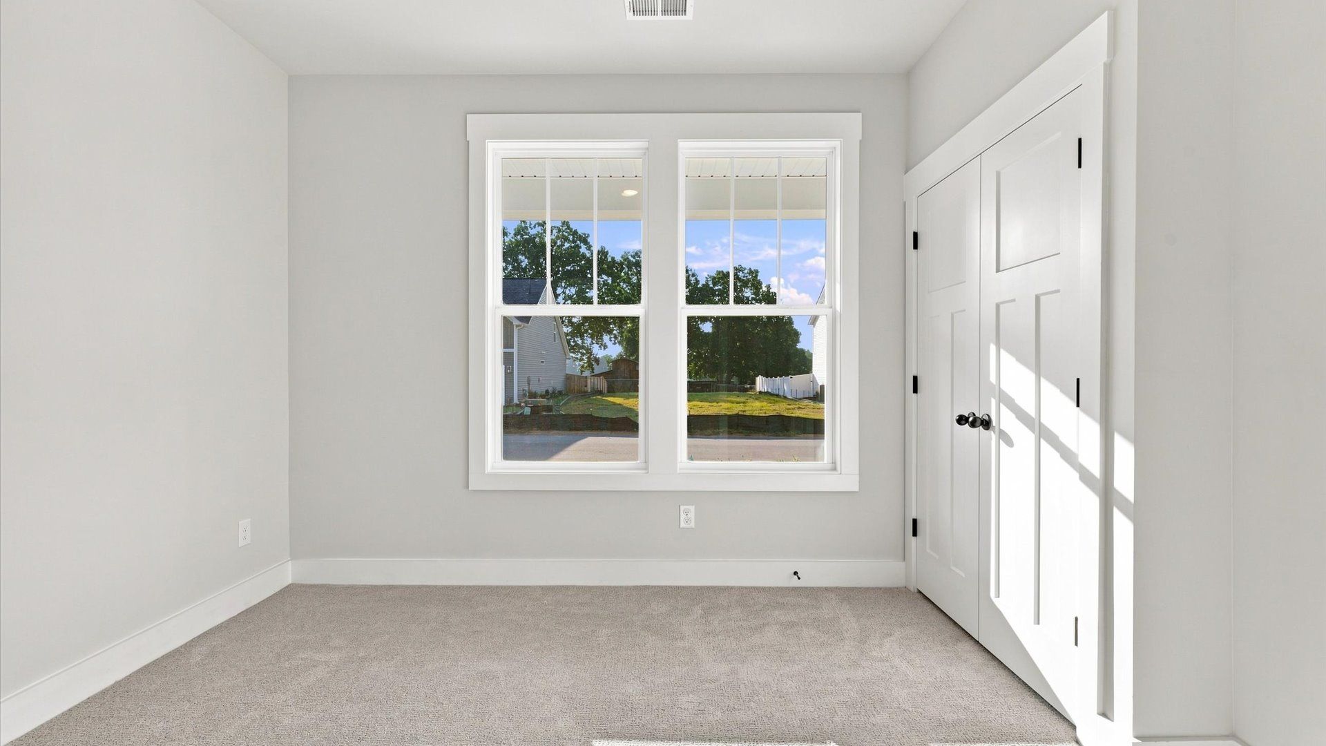 Superior comfort in this light-filled bedroom with plush carpeting and thoughtfully placed large windows