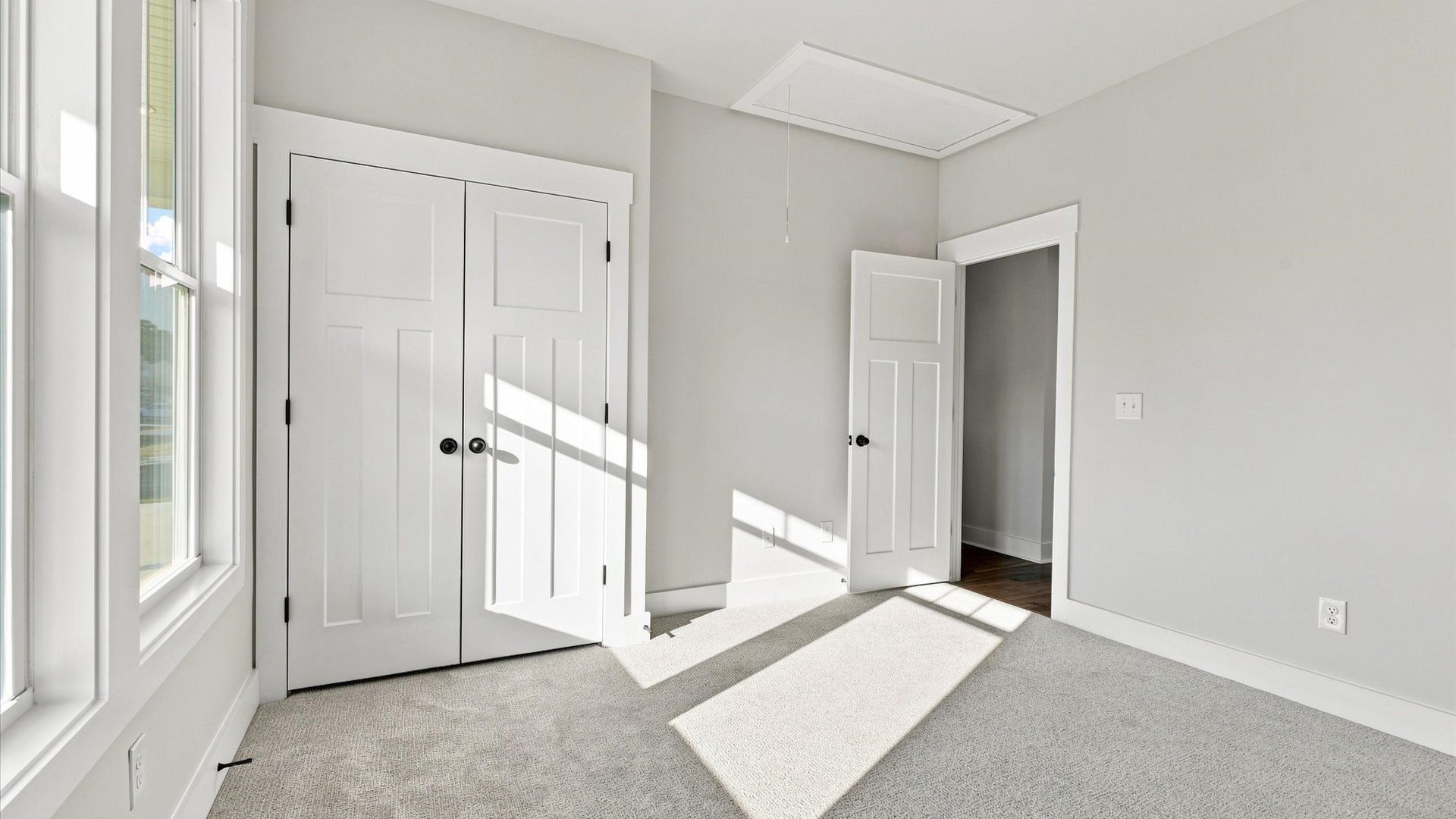 First-rate bedroom with plush carpeting and large windows that provide an open, airy feel at Walnut Ridge