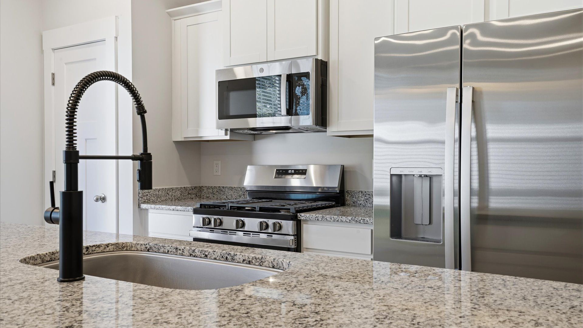 Beautifully appointed kitchen with spacious counters and sophisticated detailing by DRB Homes