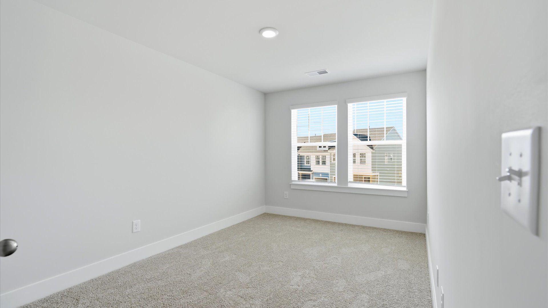 Accomplished design in this restful bedroom featuring plush carpet and oversized window views near Lake Hartwell