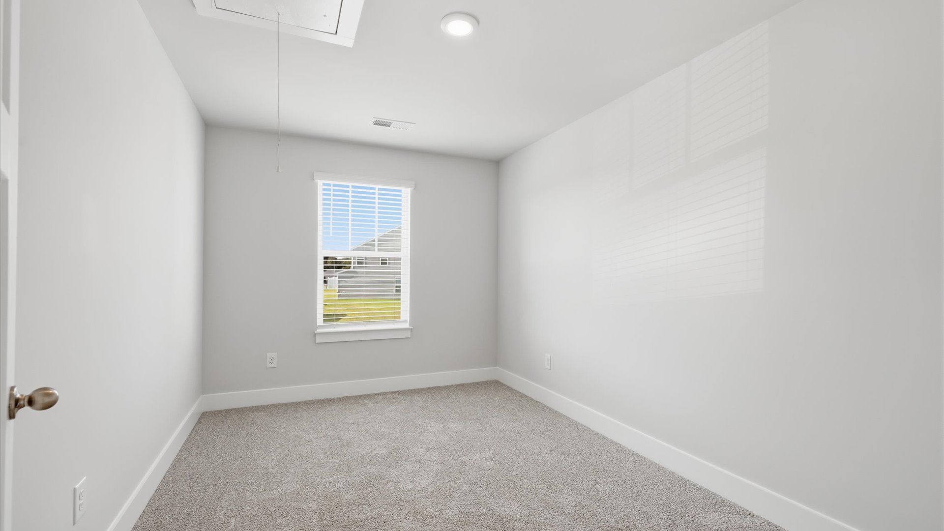 Notable bedroom offering soft carpet, a walk-in closet, and an expansive window overlooking the yard near Lake Hartwell