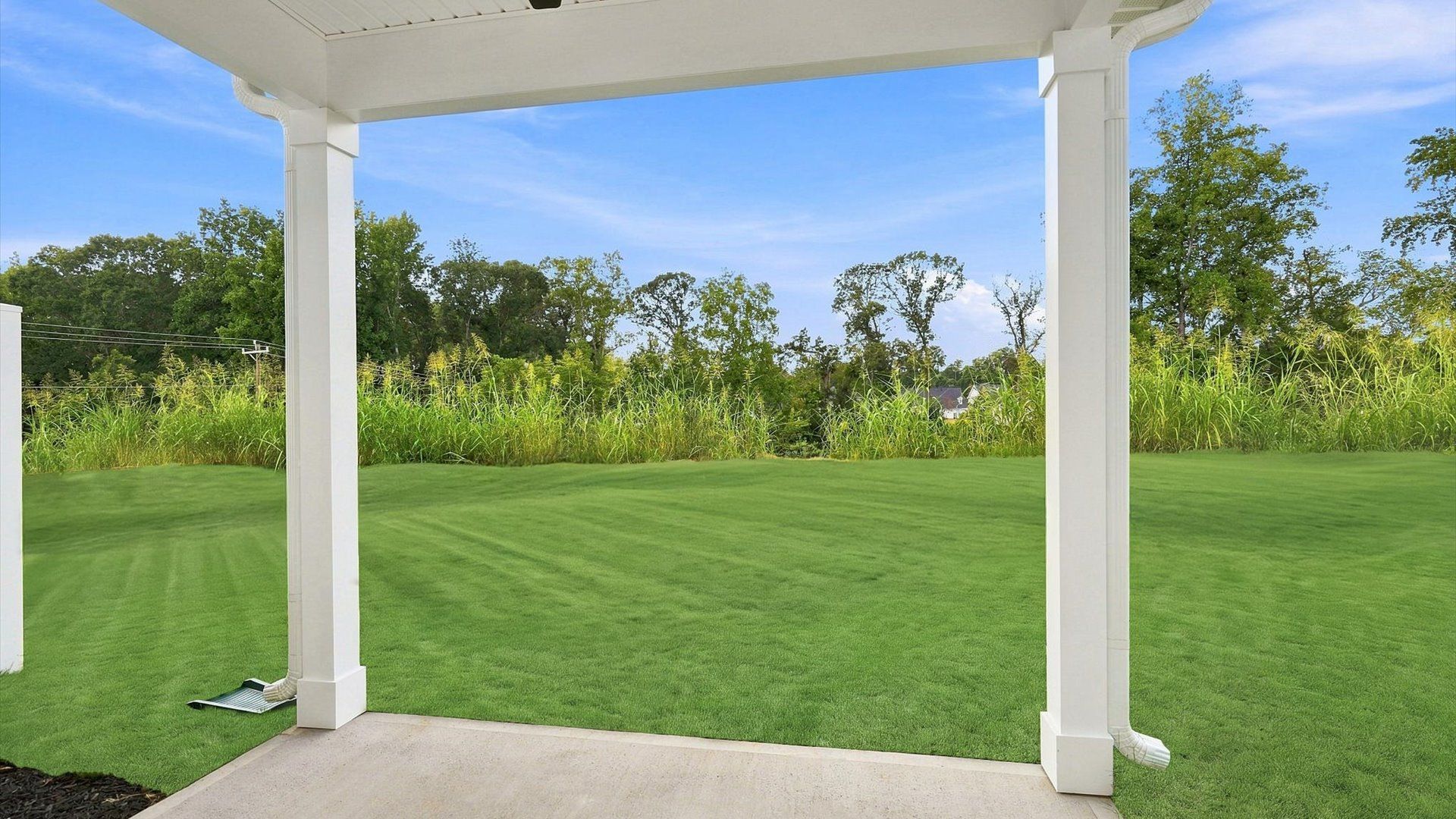 Highly functional rear covered porch adds memorable living space to this elegant home at Village at Midway