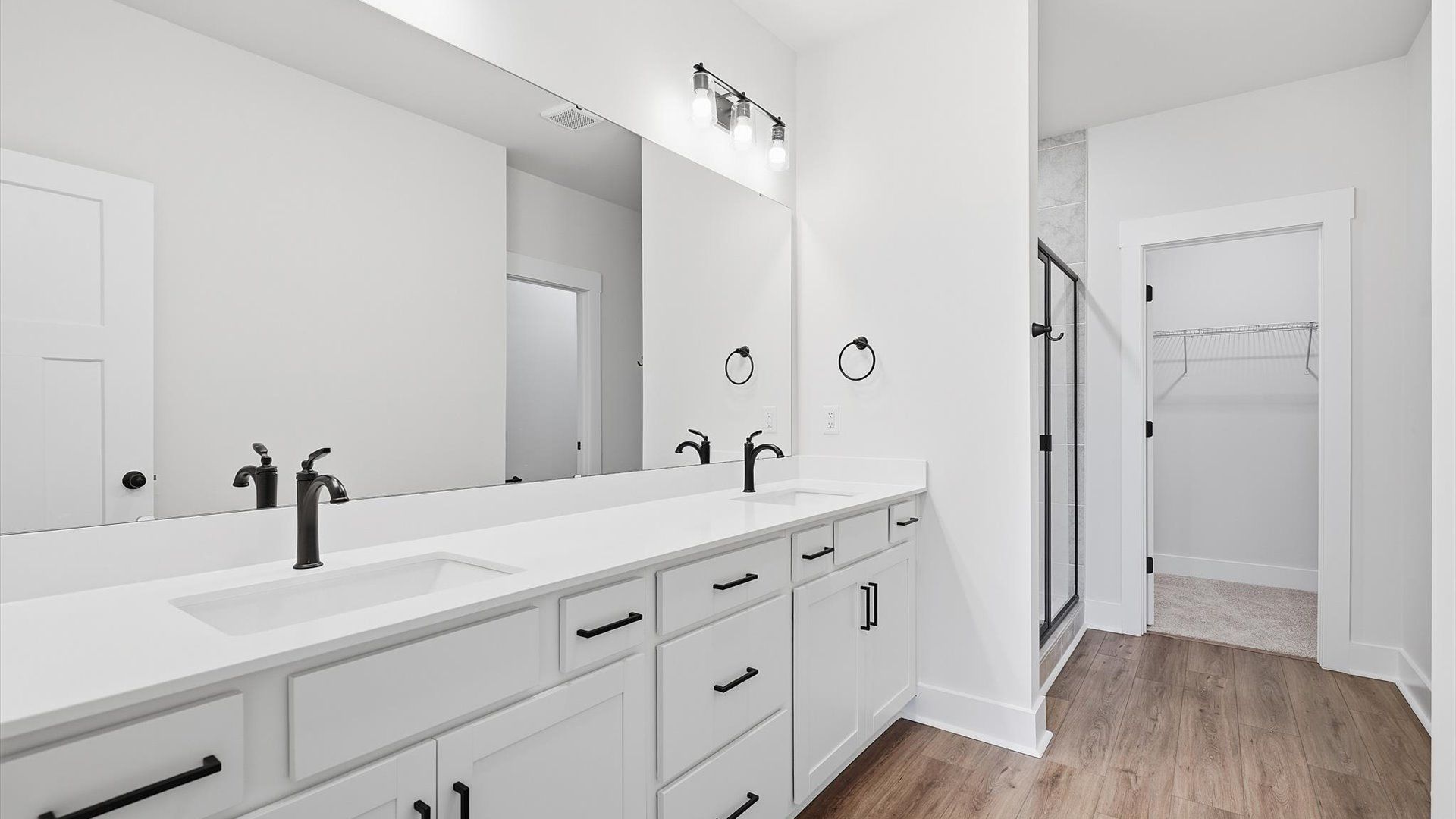 Primary bathroom designed for everyday comfort with elegant finishes throughout at Village at Midway