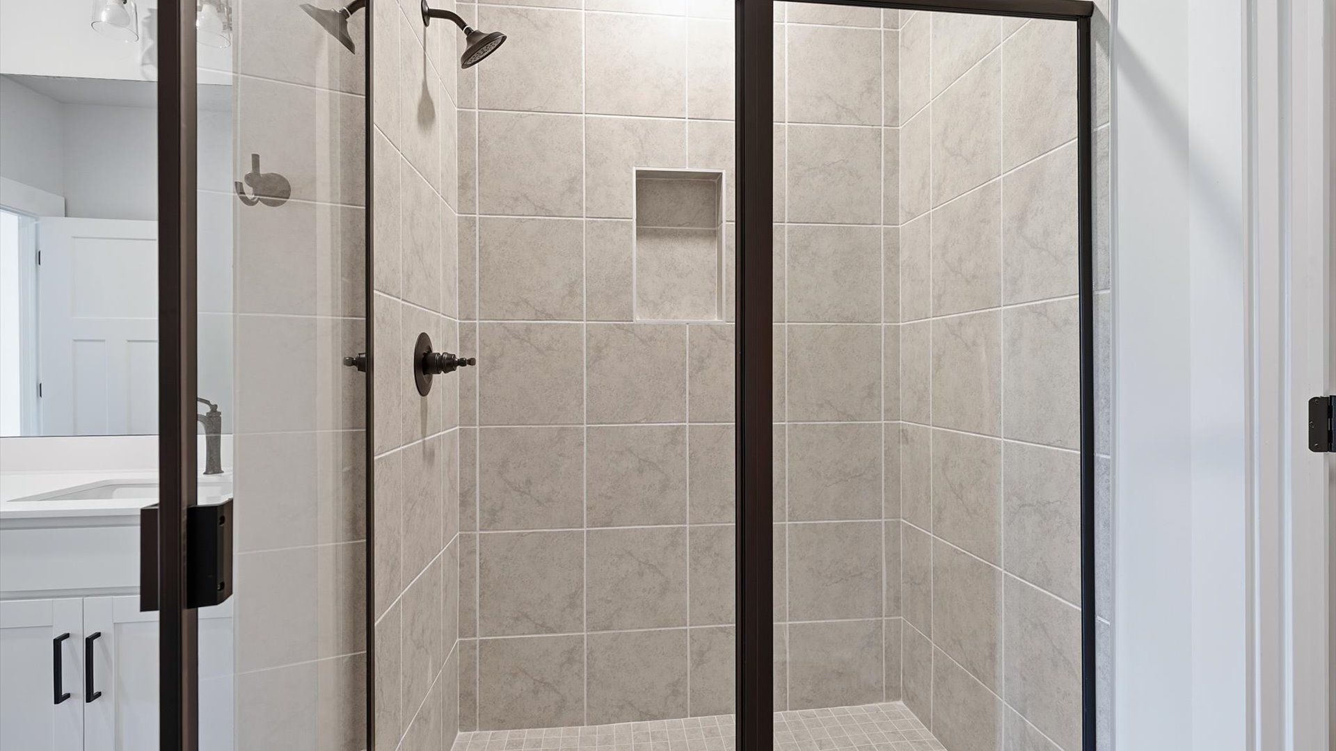 Sophisticated primary bathroom with walk-in shower and polished hardware near Lake Hartwell