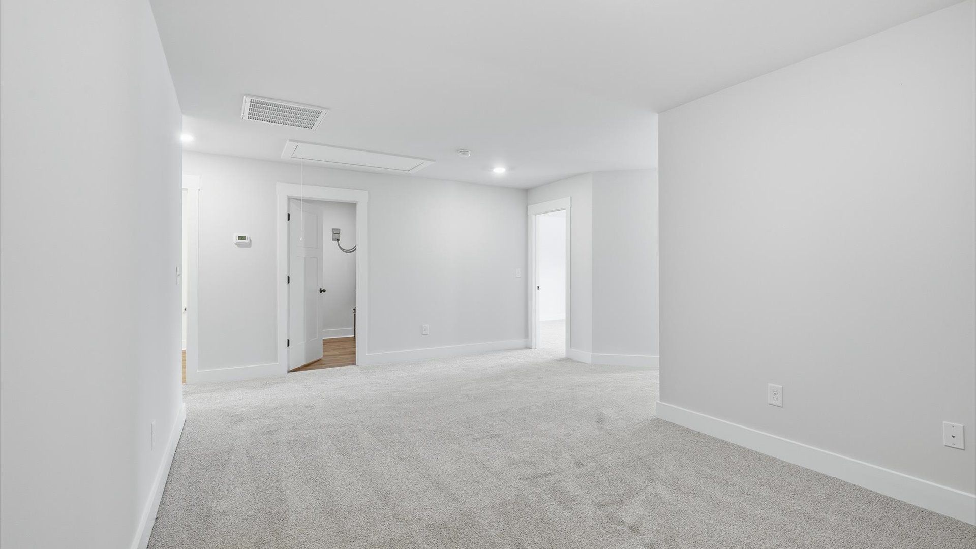 Top-notch design defines this loft with carpeted floors and an open, airy layout by DRB Homes