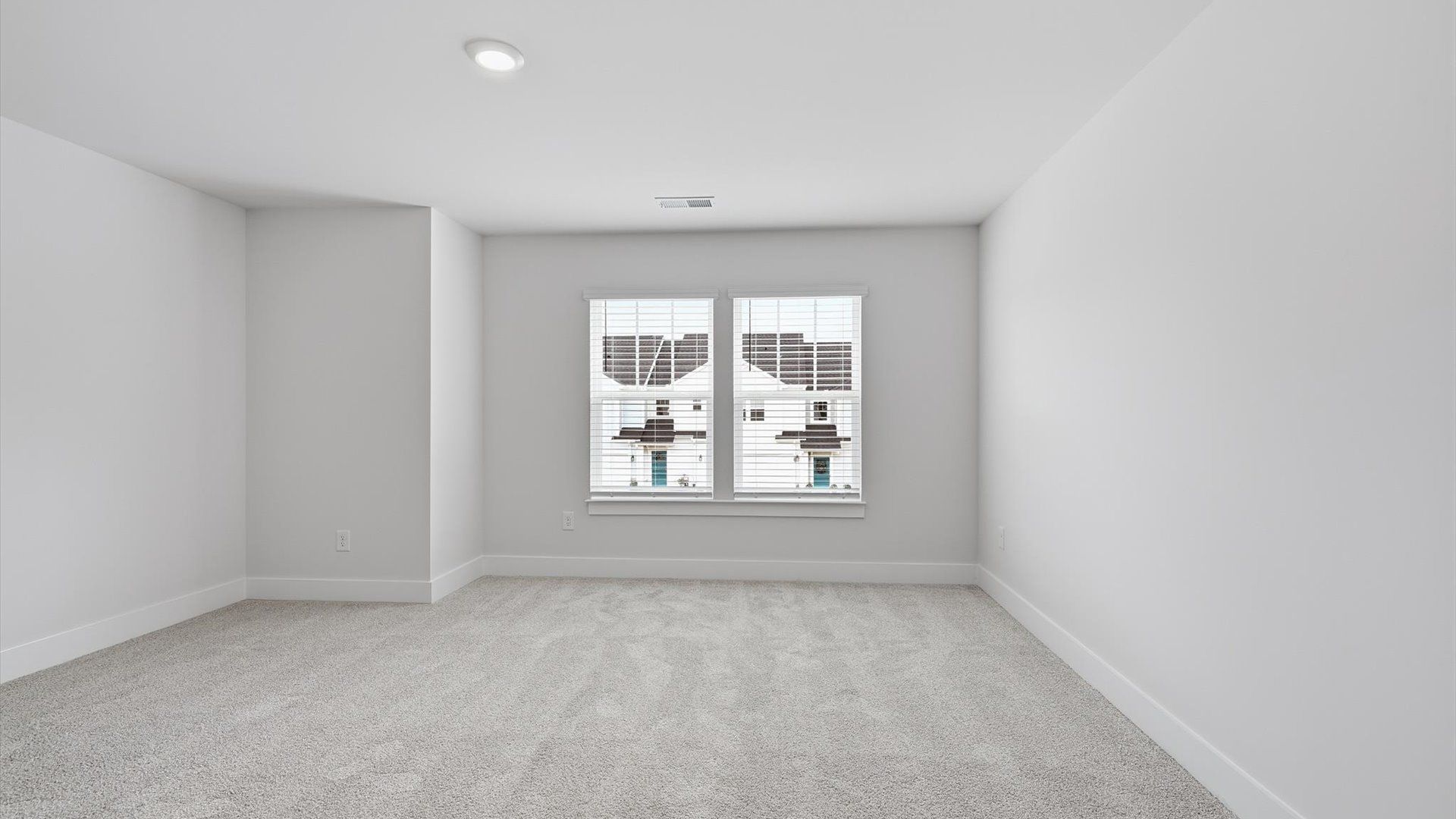 Superior comfort in this light-filled bedroom with plush carpeting and thoughtfully placed large windows
