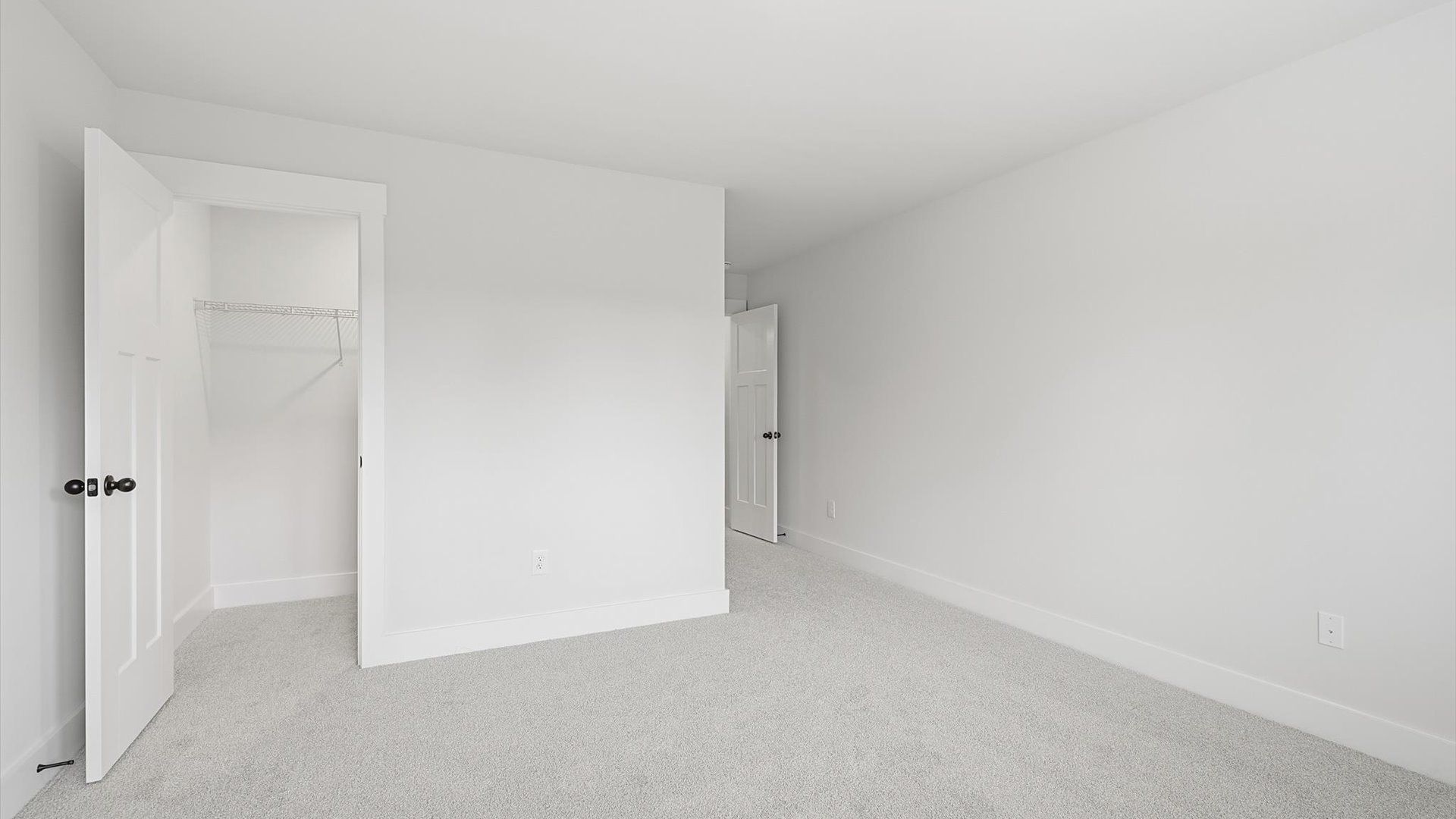 Notable secondary bedroom offering cozy carpeted flooring and a stylish walk-in closet by DRB Homes