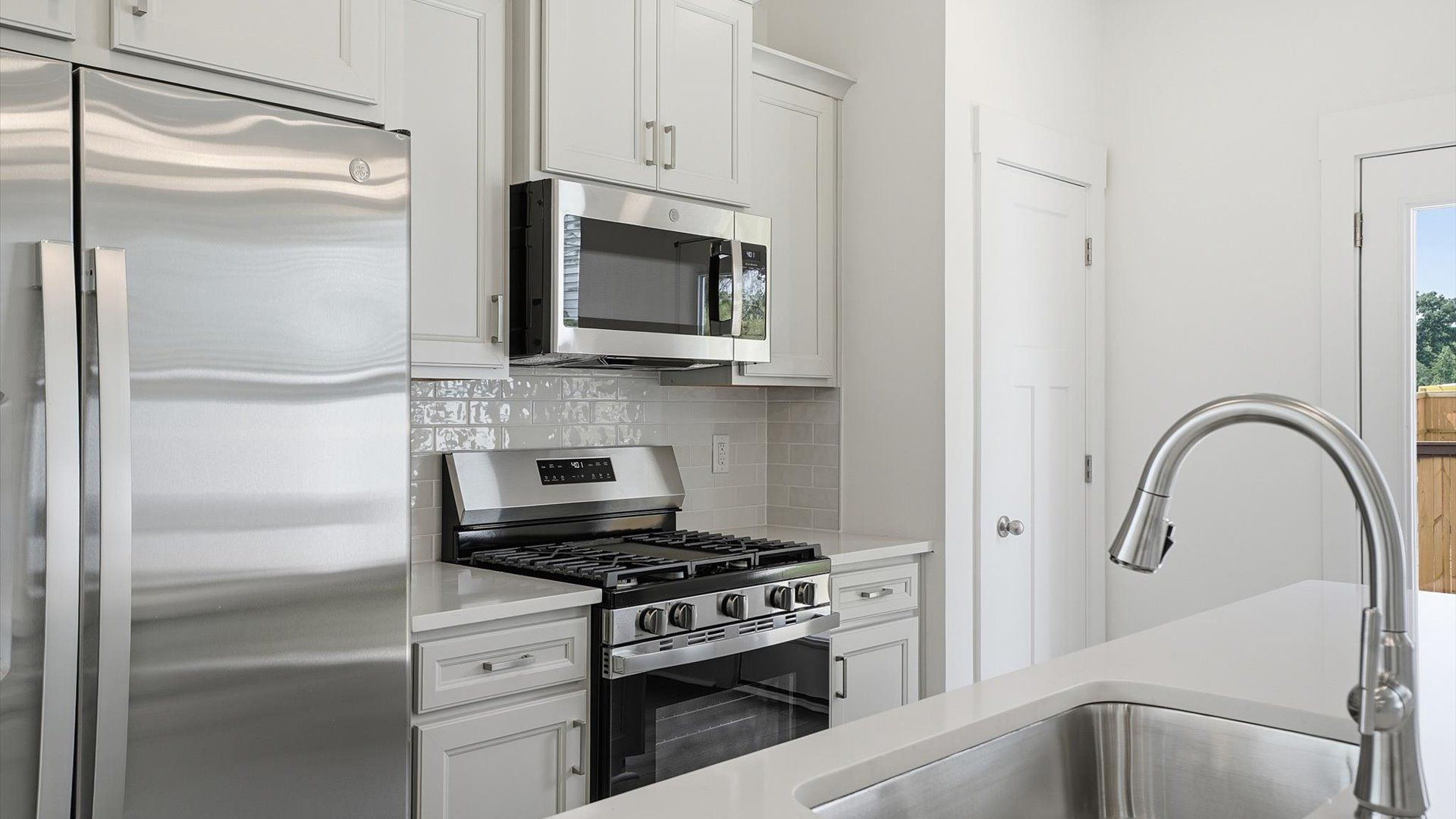 Luxury-inspired kitchen featuring expansive prep space and elegant design elements by DRB Homes
