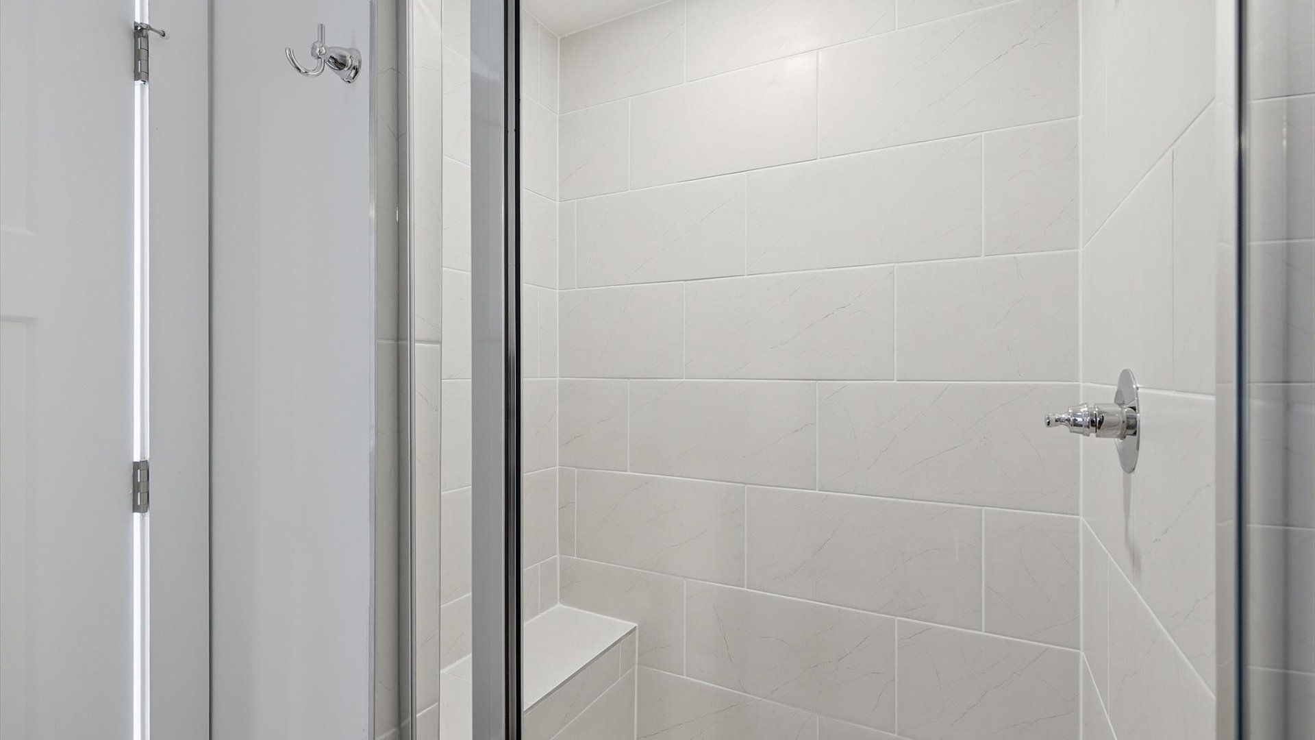 Sophisticated primary bathroom with expansive walk-in shower and polished hardware located at Barton Hollow