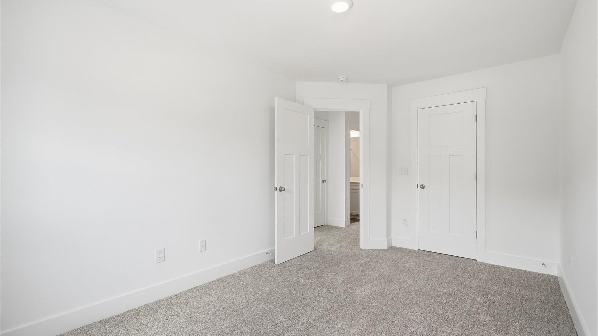 Elegant bedroom retreat featuring soft carpeting and a thoughtfully designed walk-in closet by DRB Homes