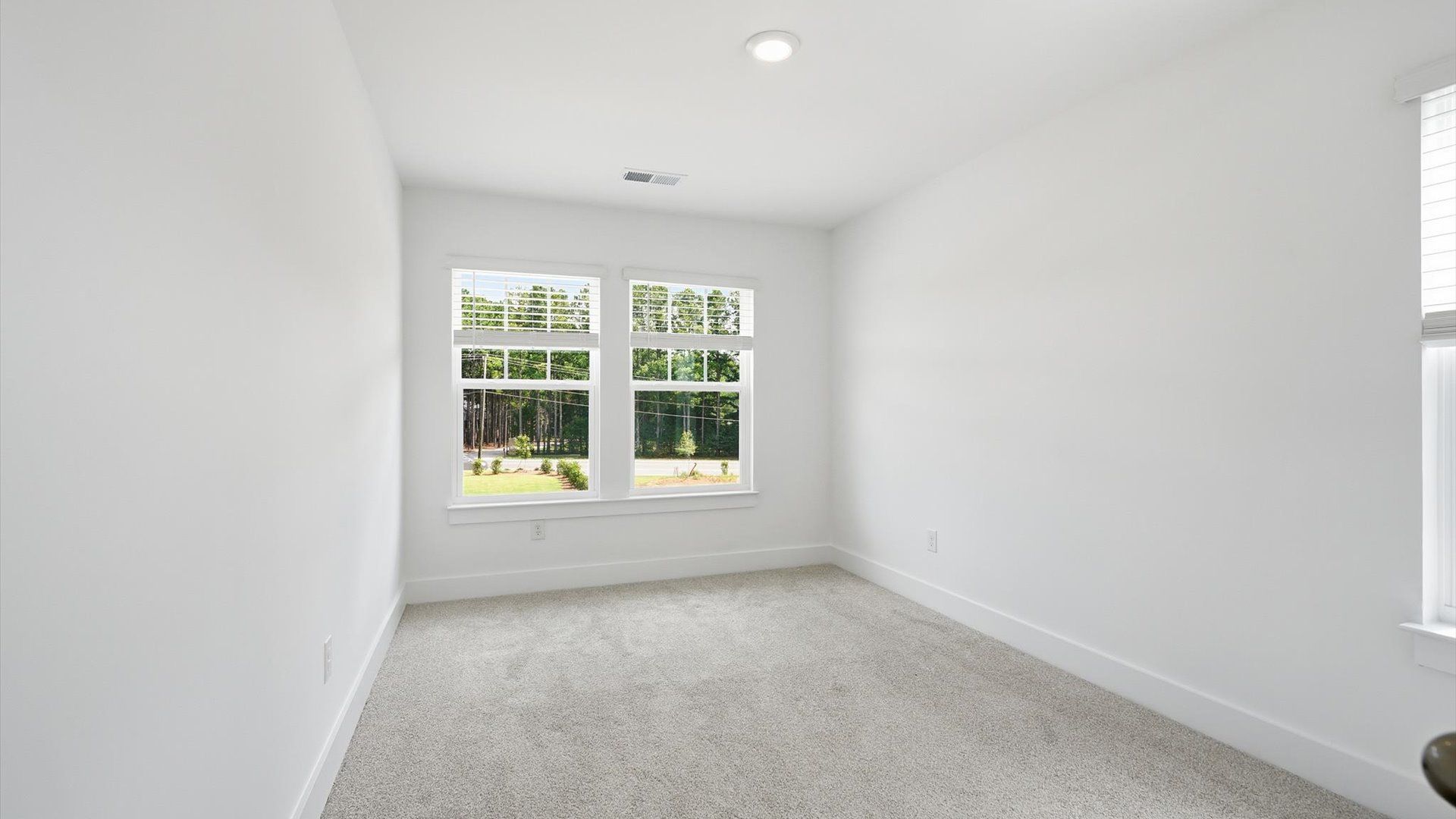 Refined bedroom design with large windows for daylight-filled mornings and peaceful views at Barton Hollow