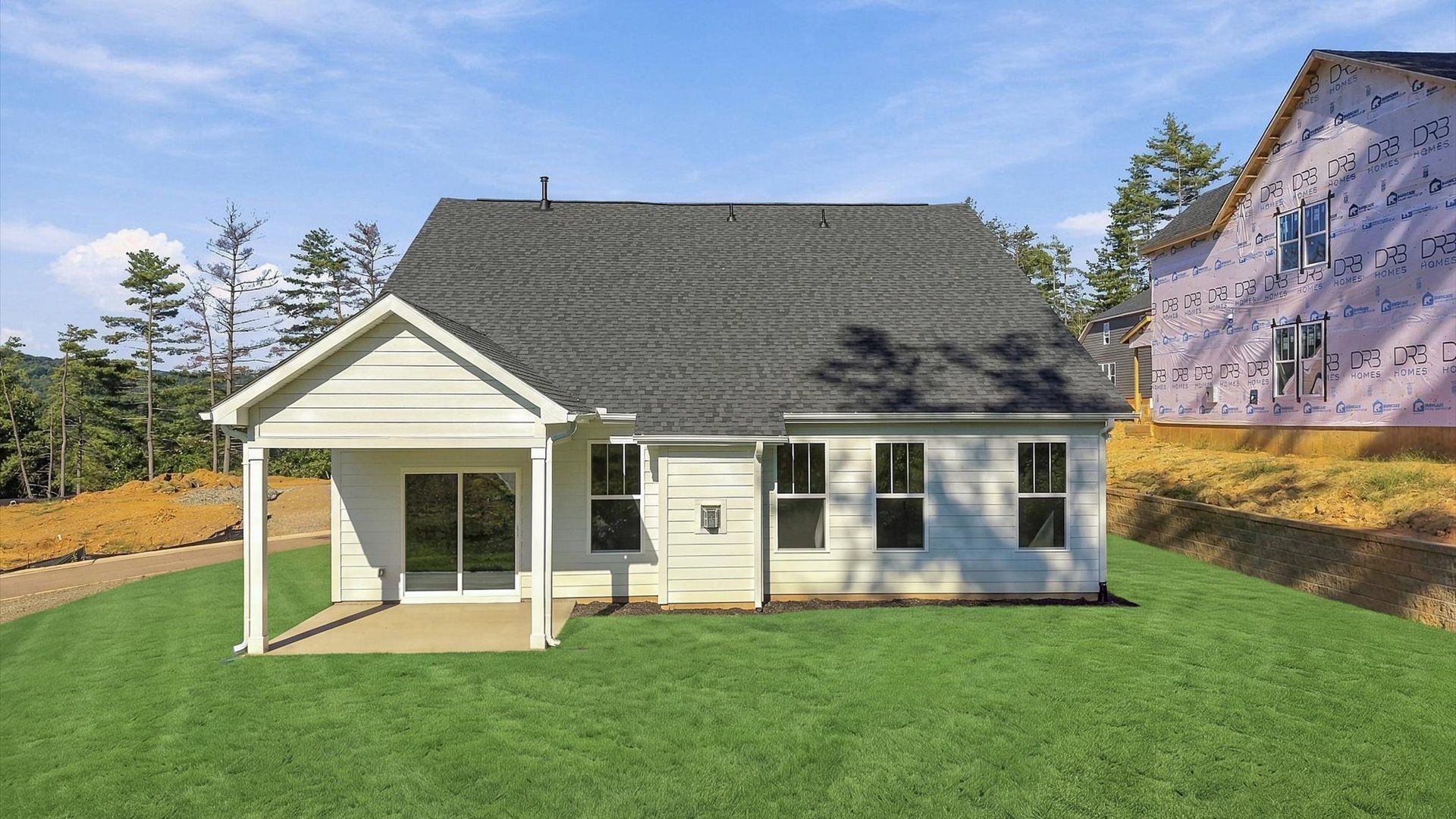 Vibrant rear outdoor space featuring a covered porch and exceptional craftsmanship