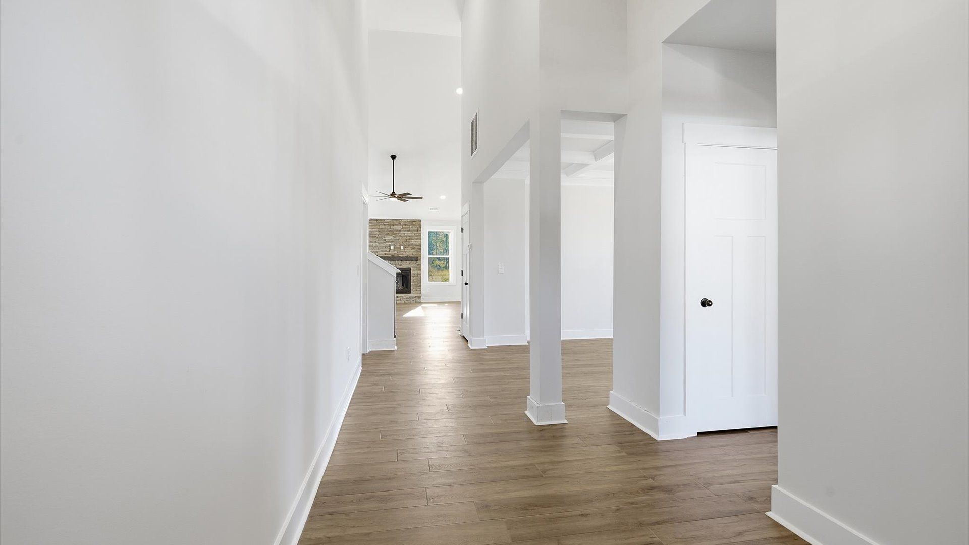 Exceptional foyer with warm hardwood flooring and refined finishes throughout