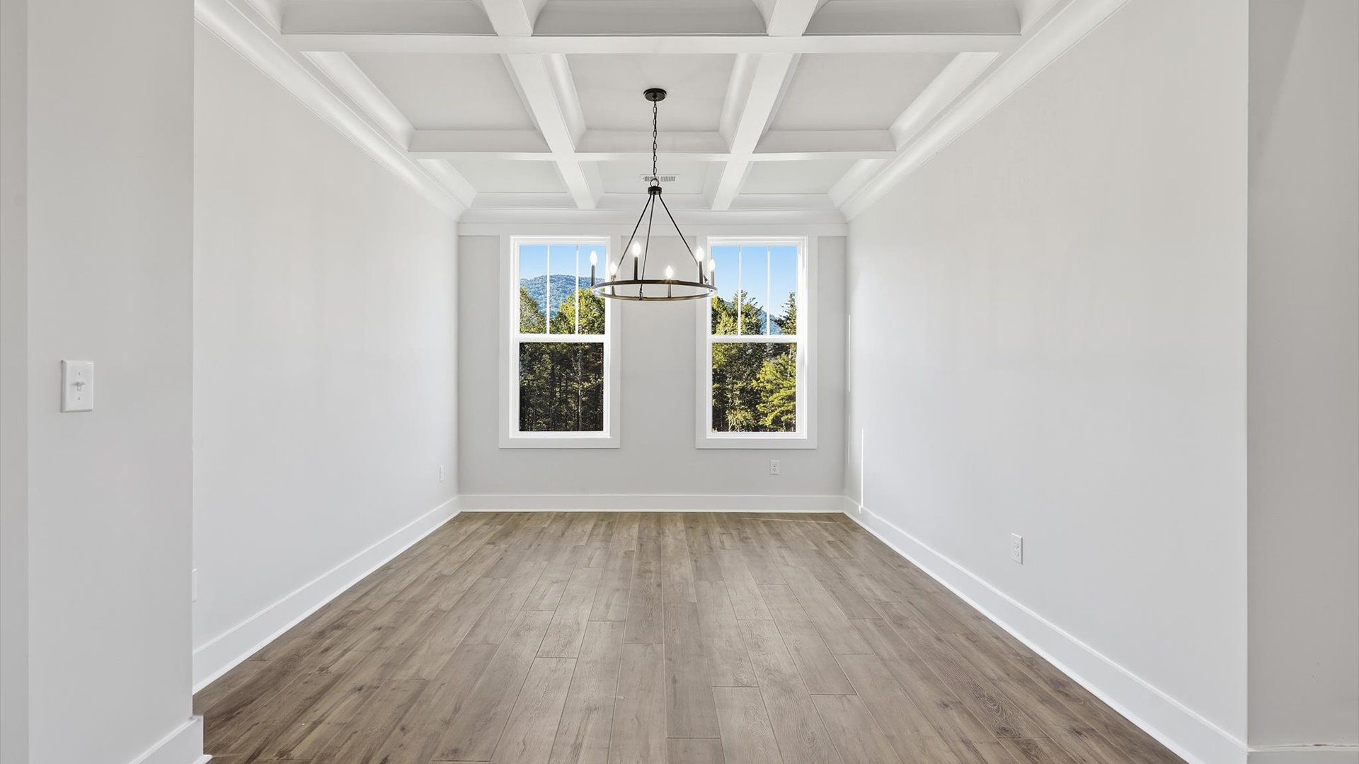 Eye-catching coffered ceiling adds charm to the formal dining space in this superior DRB Homes design