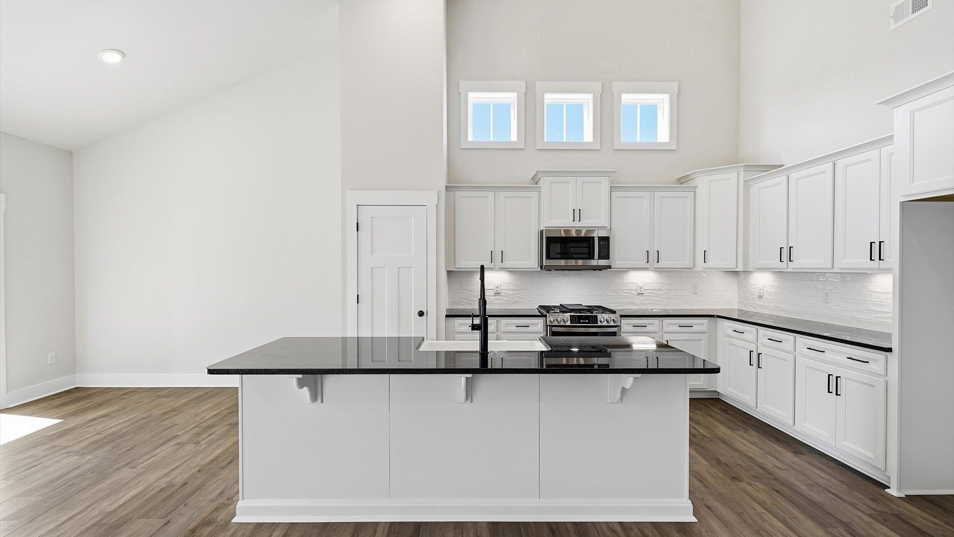 Superior craftsmanship shines in this modern kitchen with an oversized island and open flow