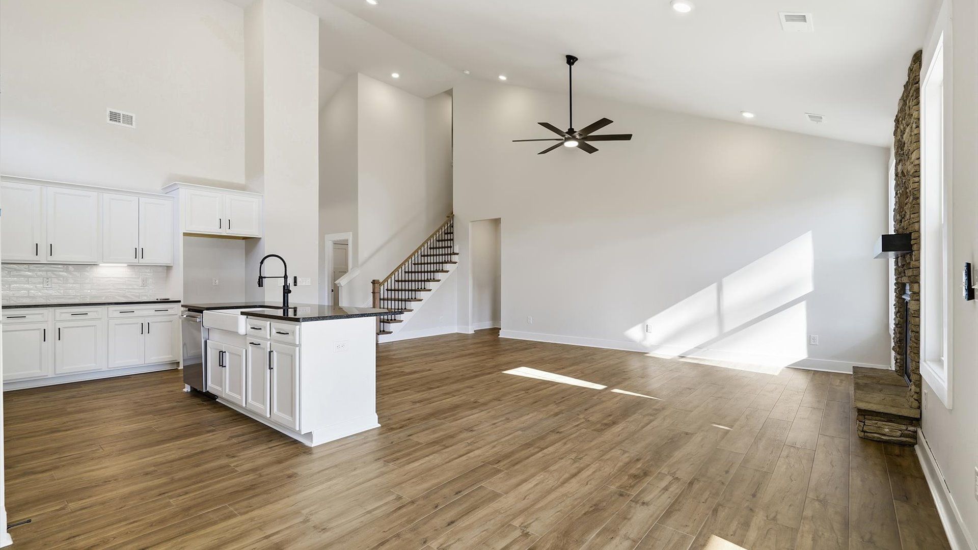 Accomplished design shines in this vibrant family room with dramatic two-story ceilings and open-concept flow