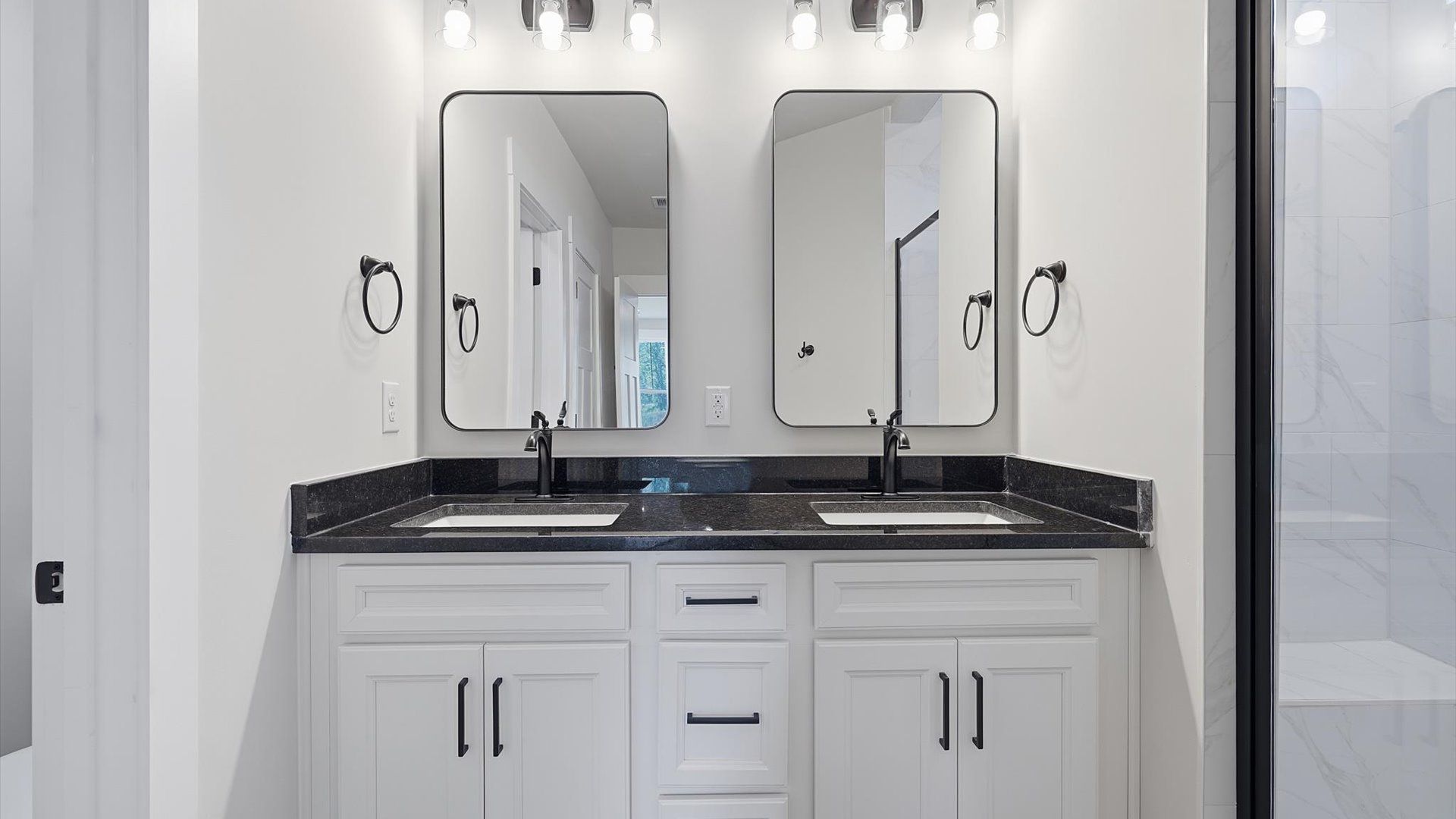 Highly functional and elegant en-suite with dual vanities, tiled walk-in shower, and refined finishes