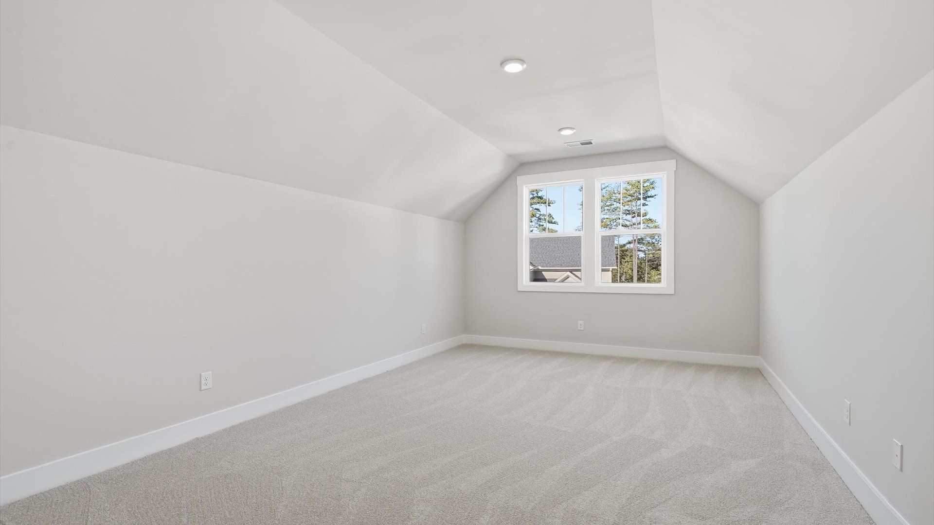 Highly functional bonus room featuring cozy carpet and open views of the home’s living areas