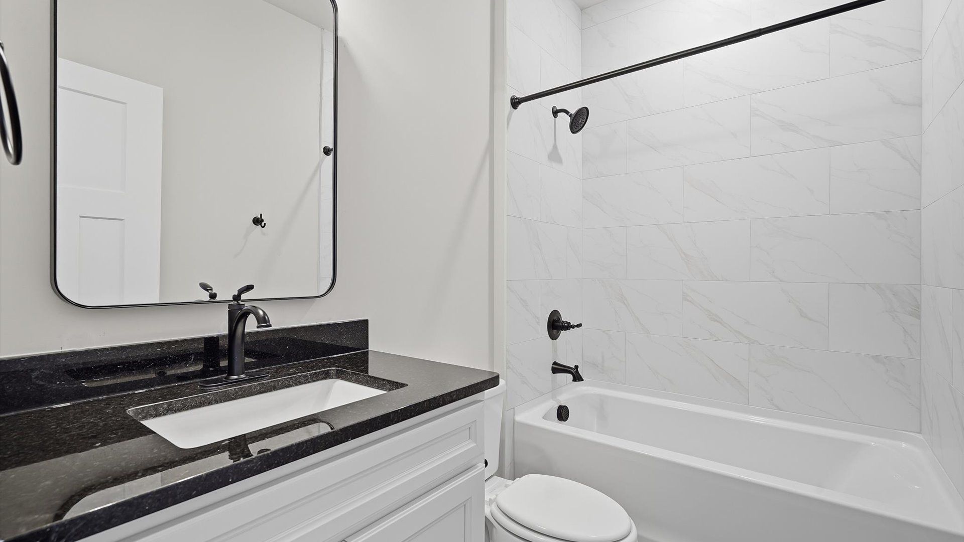 First-rate full bath featuring tiled shower, modern surfaces and a fresh, current color palette
