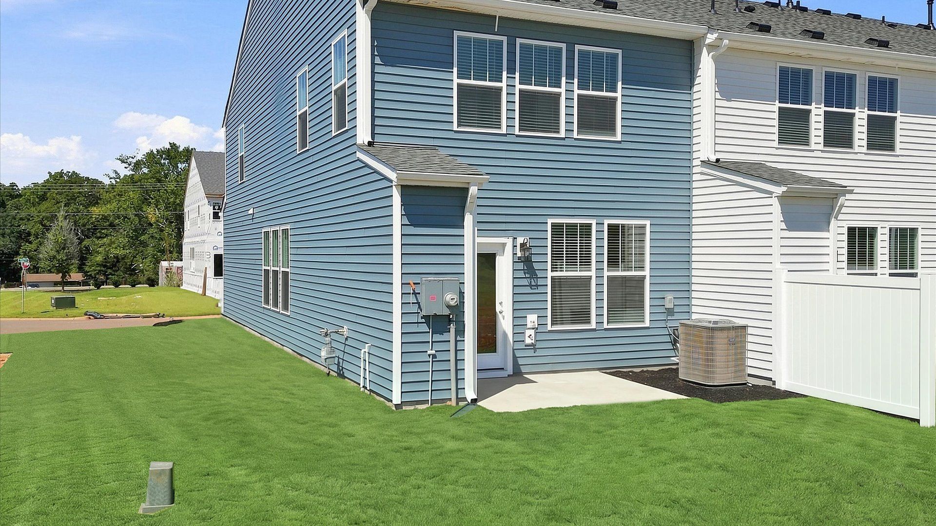 Refined rear exterior with a stylish patio for dining, relaxing, or entertaining by DRB Homes