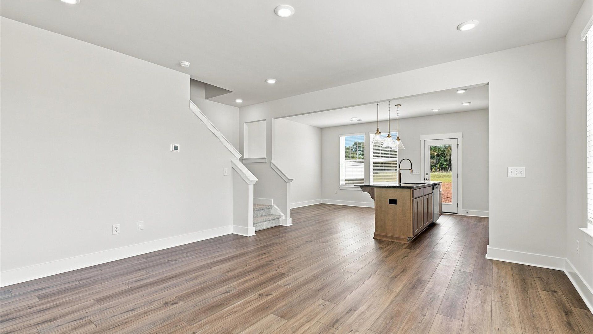 First-rate family room with thoughtful layout and superior connection to kitchen and dining spaces at Saluda Crossing